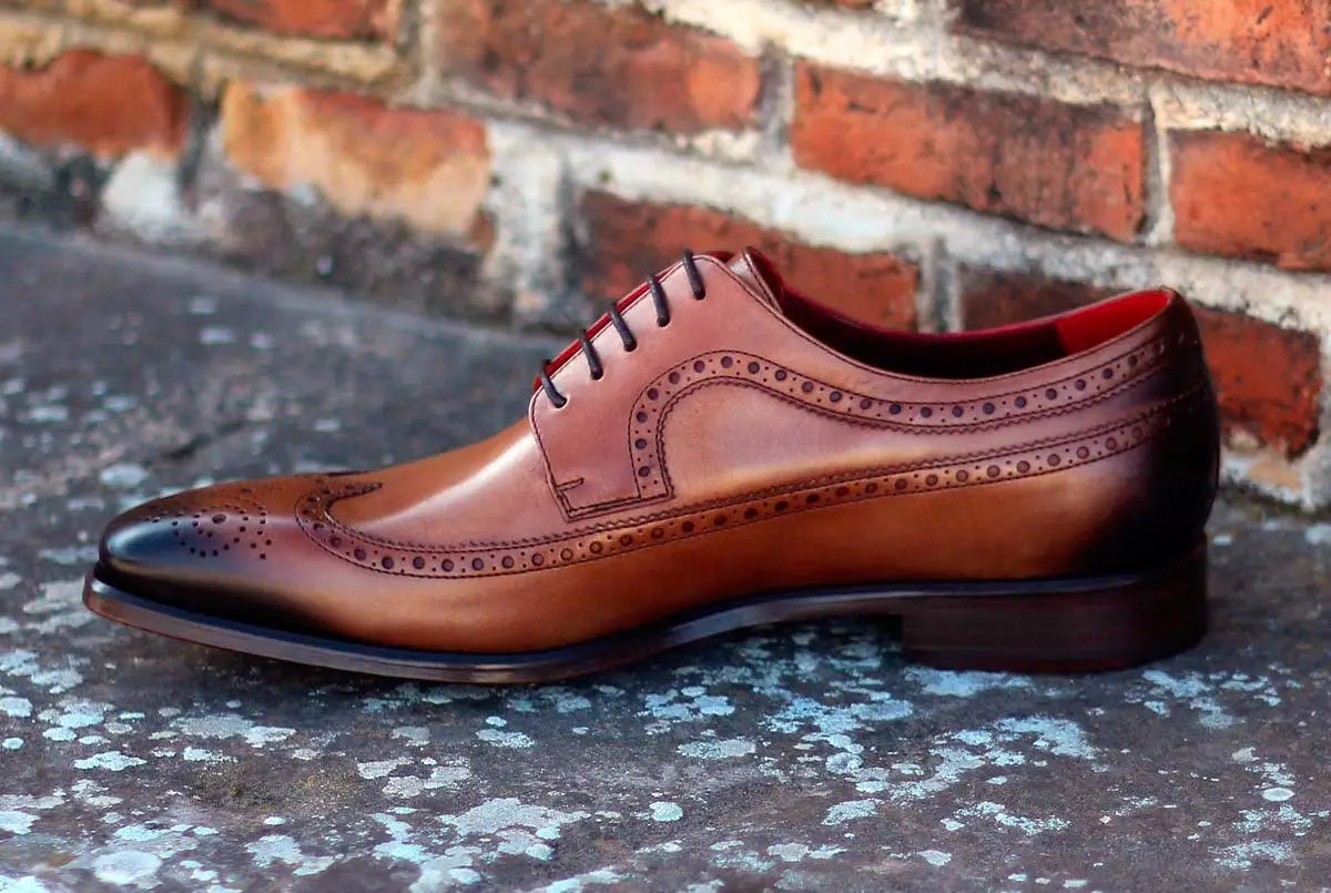 Brown leather wingtip dress shoe.