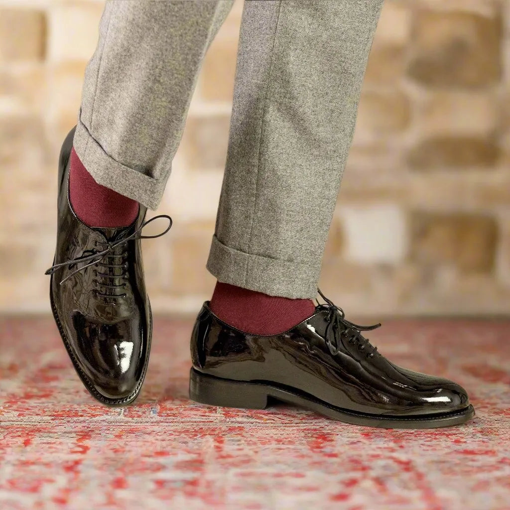 Black patent leather oxford shoes with polished finish and dark laces.