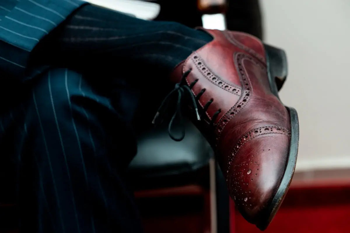 person wearing brown leather shoe