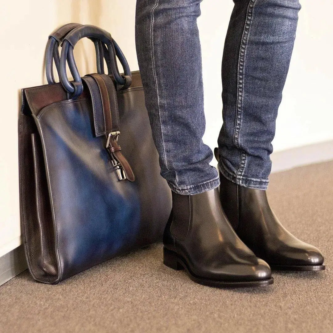 Leather briefcase and black boots.