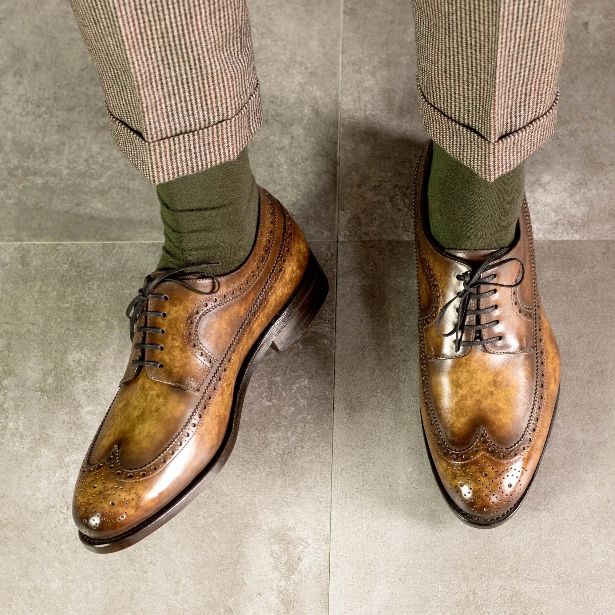 Brown leather wingtip dress shoes.