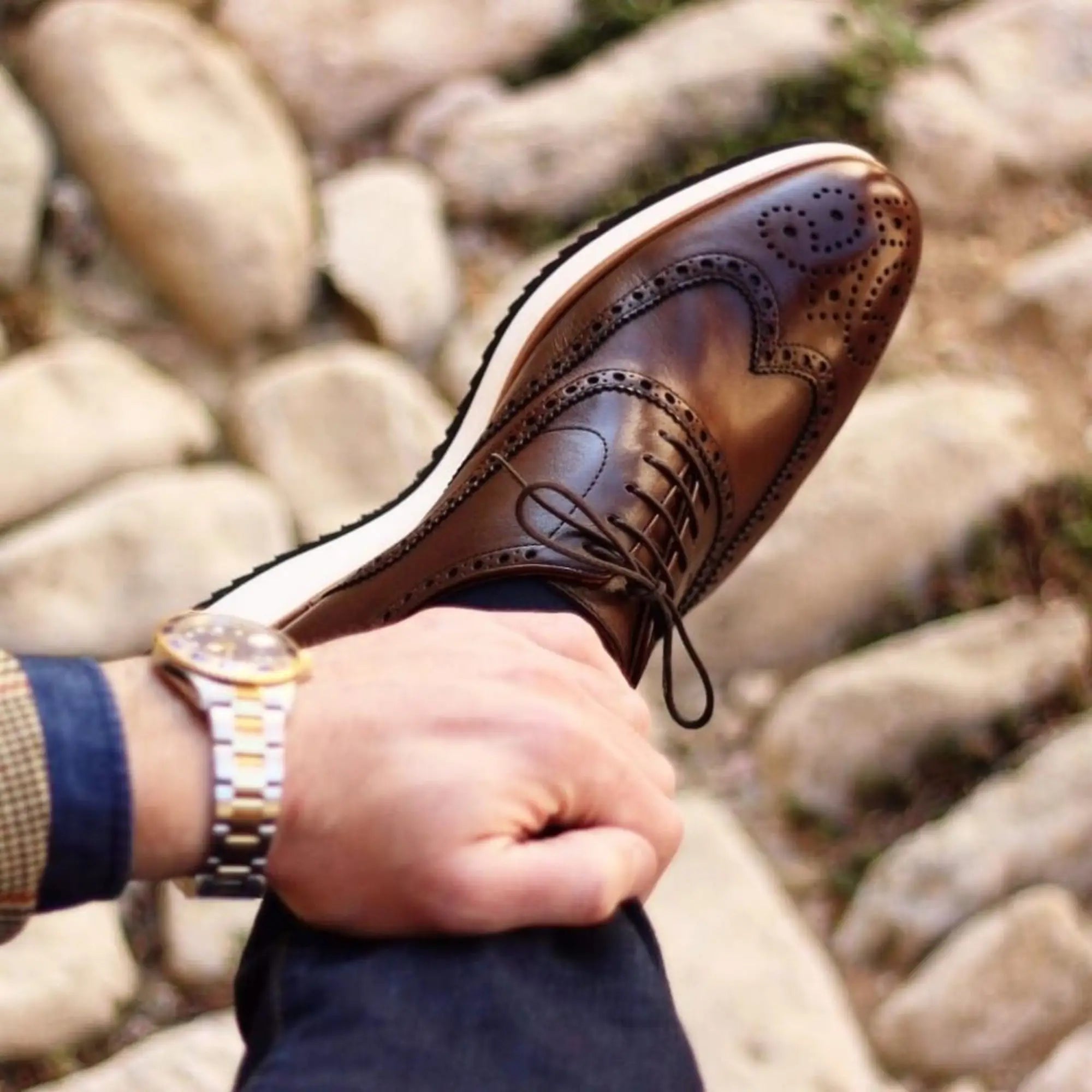 Brown leather wingtip shoe.