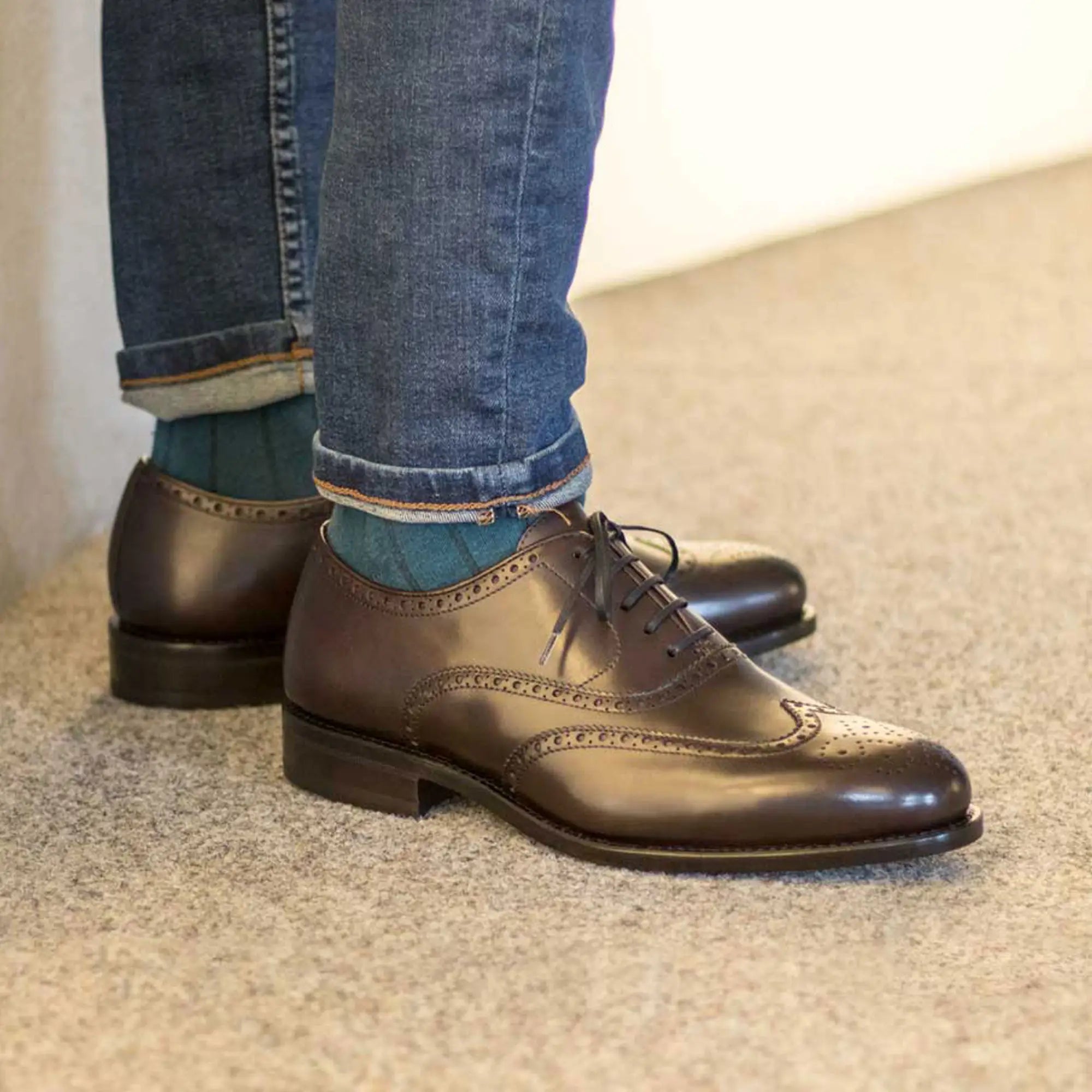 Brown leather wingtip dress shoes.