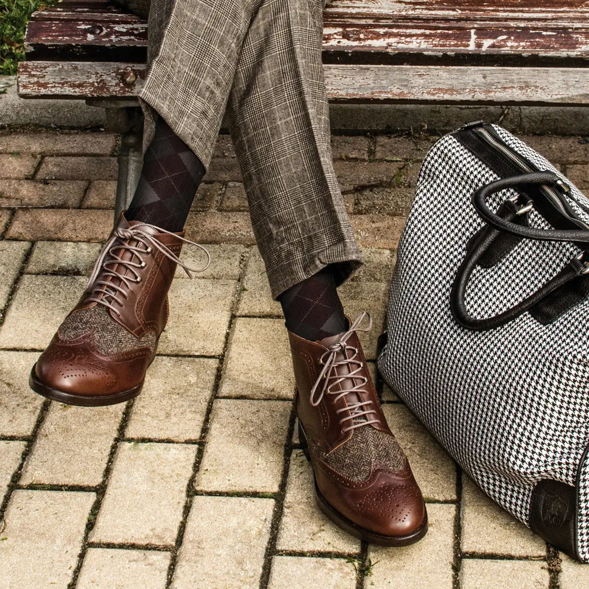 Brown leather and tweed wingtip boots.
