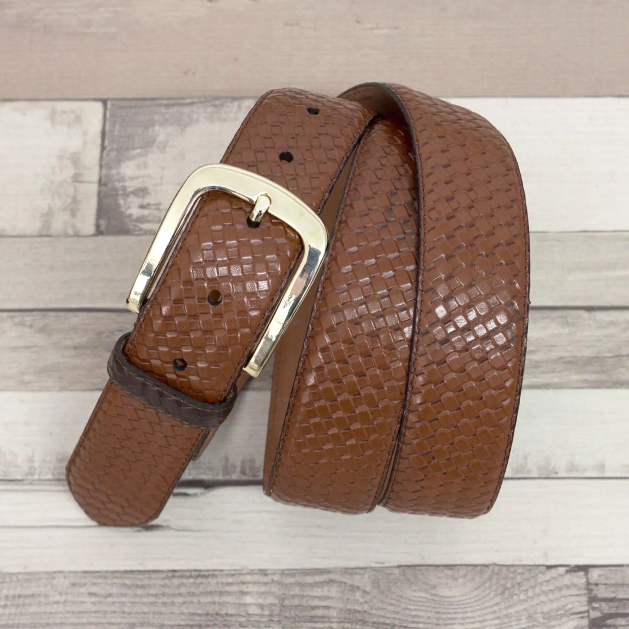 Brown woven leather belt with silver buckle.