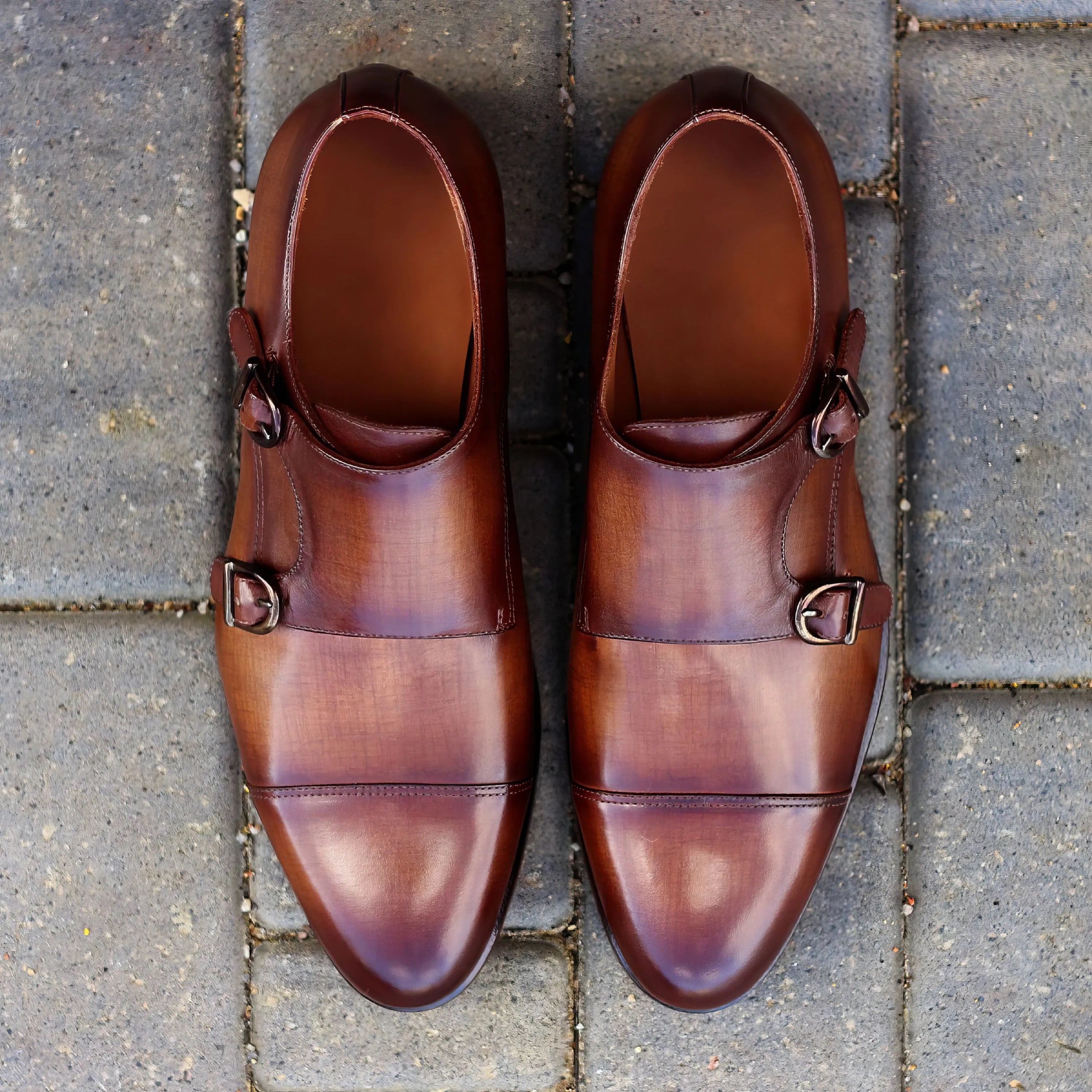 Pair of brown leather double monk patina shoes for stylish formal wear