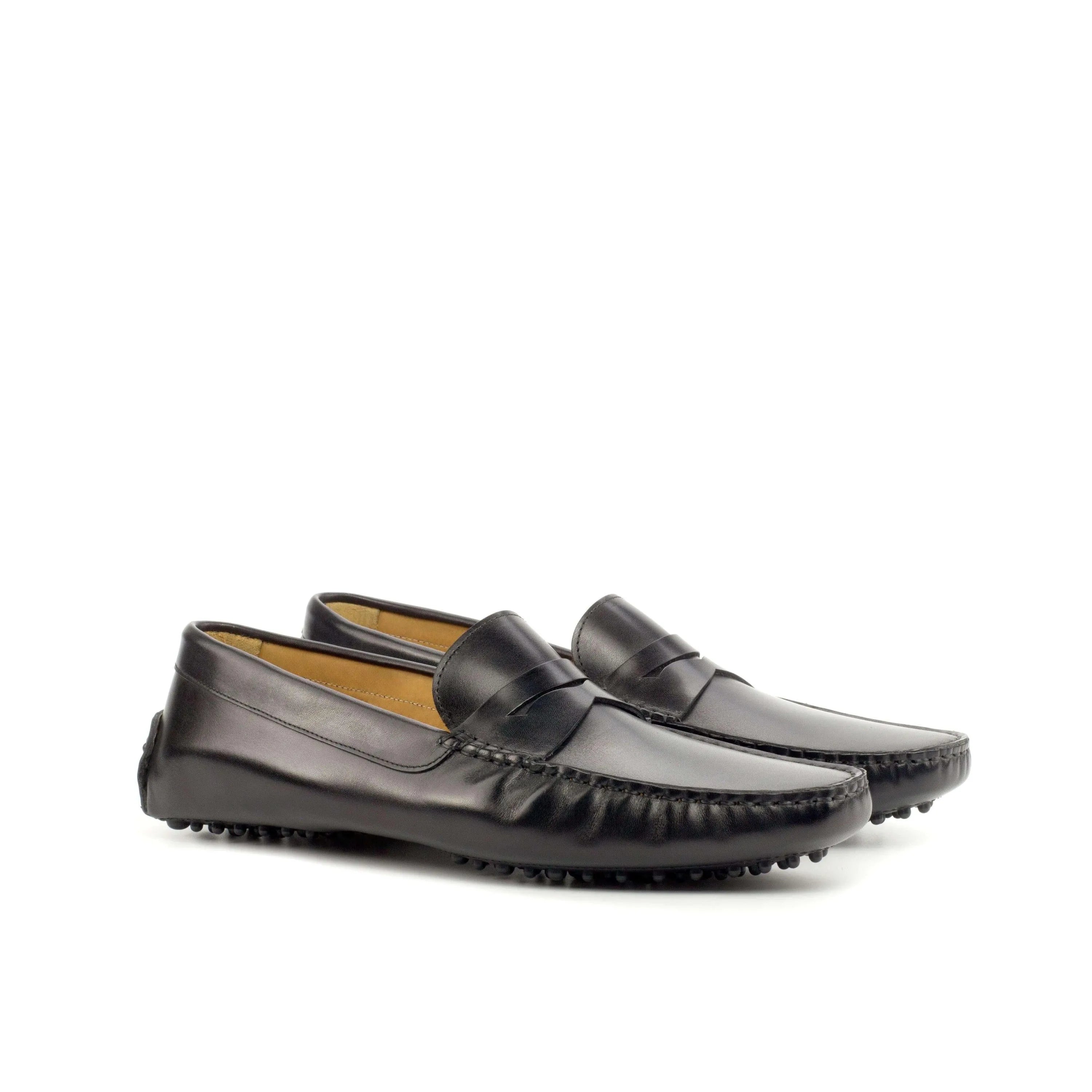 Black leather penny loafers named 1963 Driver featuring rubber soles for driving comfort