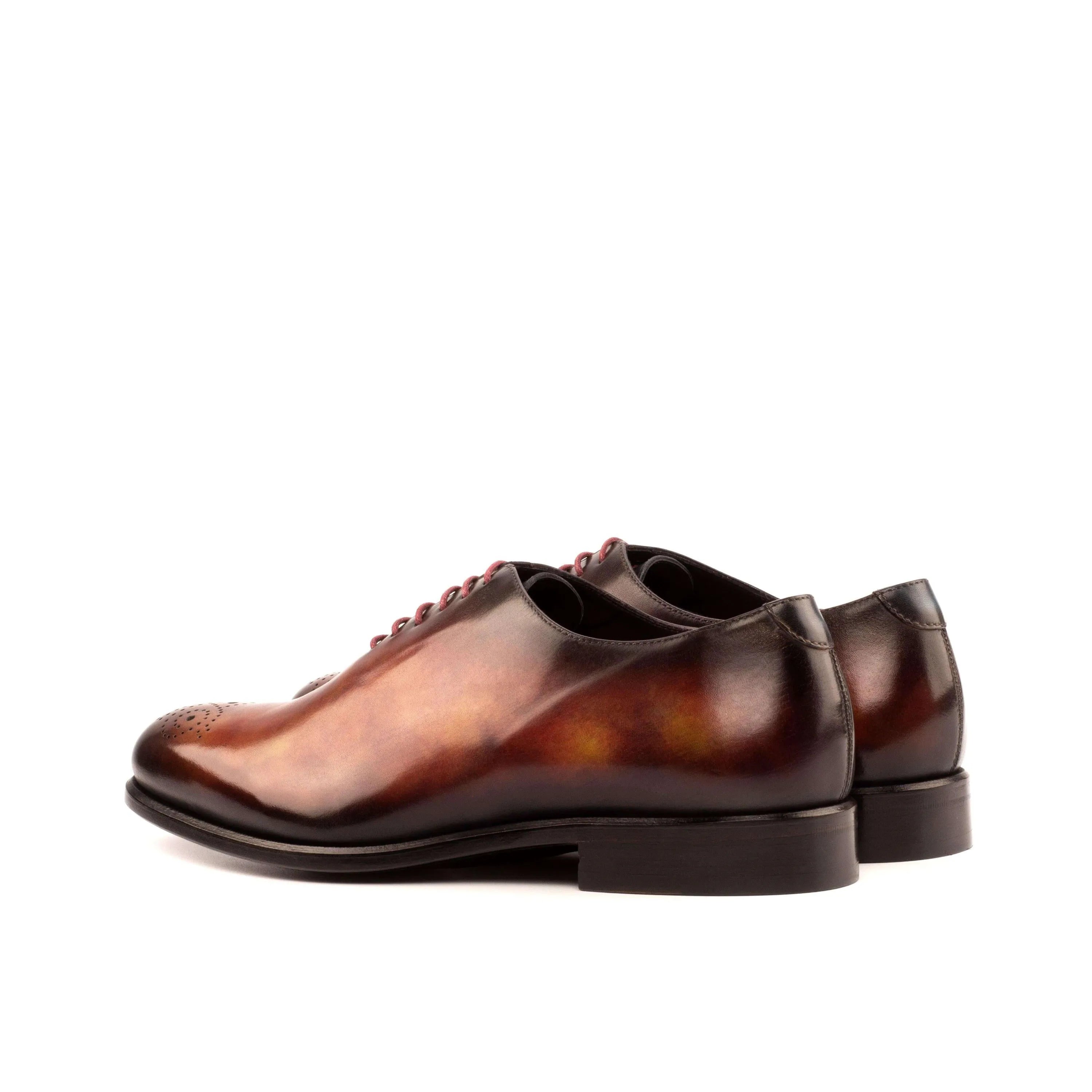 Brown leather dress shoes featuring a rounded toe, part of the 50 Whole Cut Patina II collection