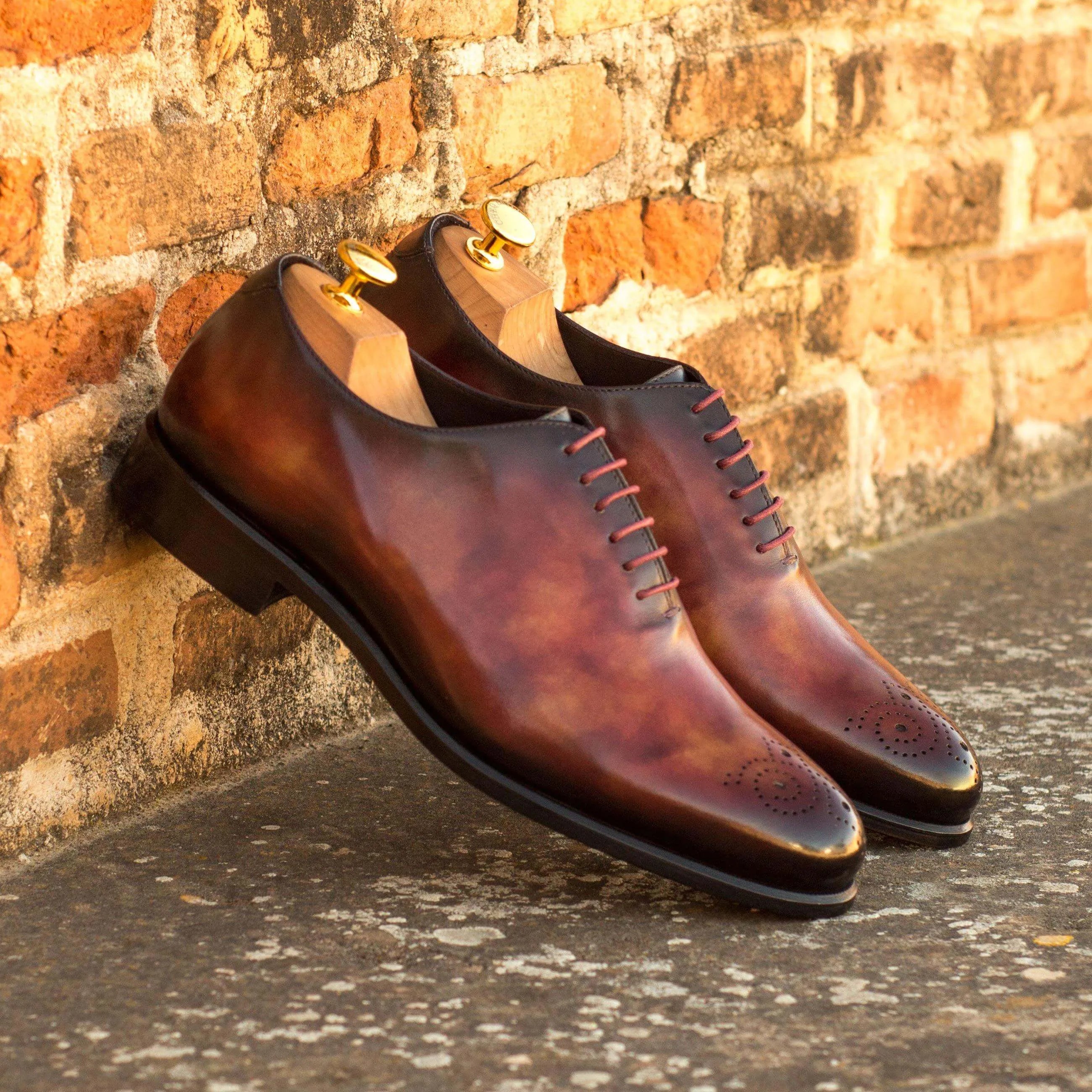 Pair of brown leather dress shoes featuring rounded toe in 50 Whole Cut Patina II