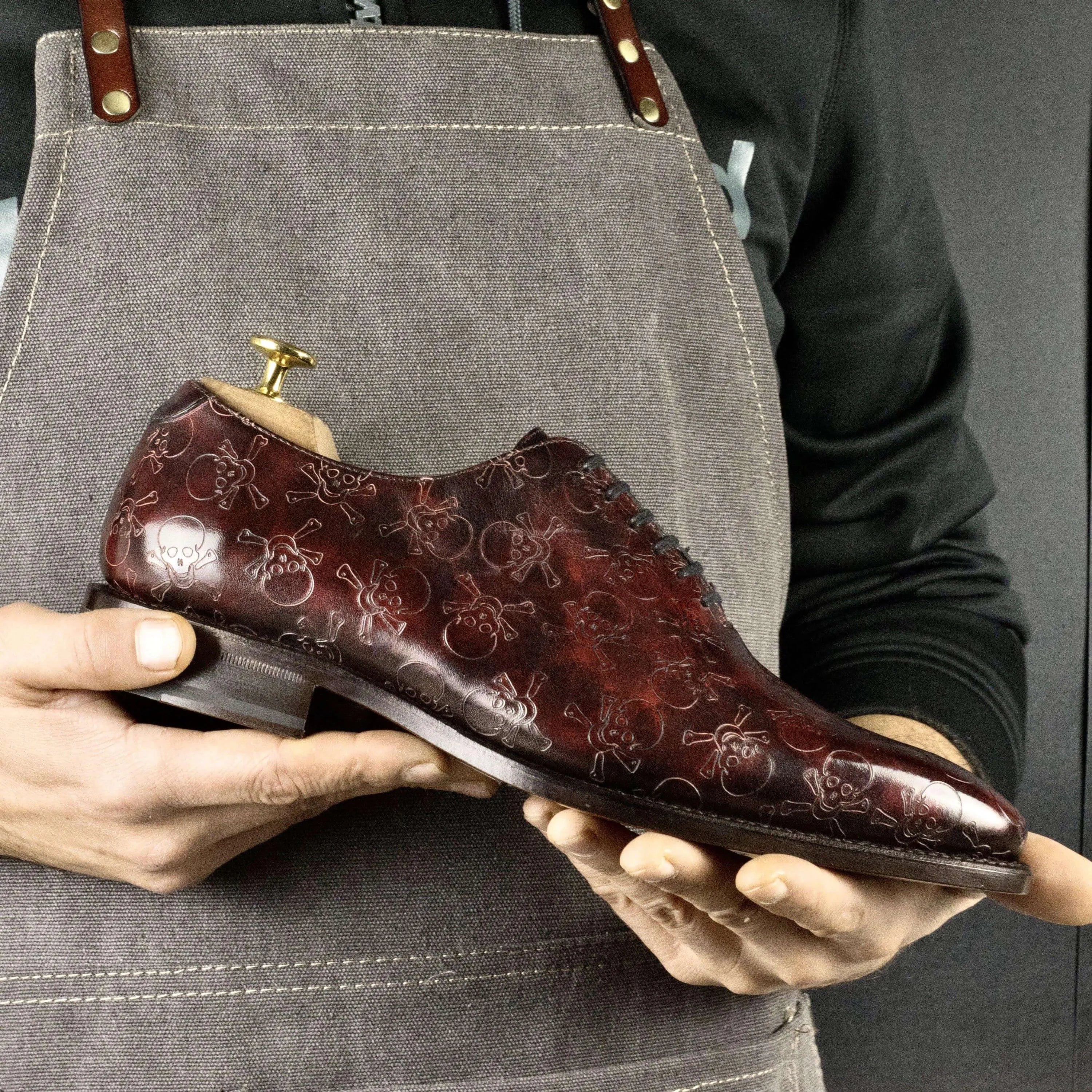 Burgundy leather Almalo Patina Wholecut Shoes featuring a distinctive skull pattern