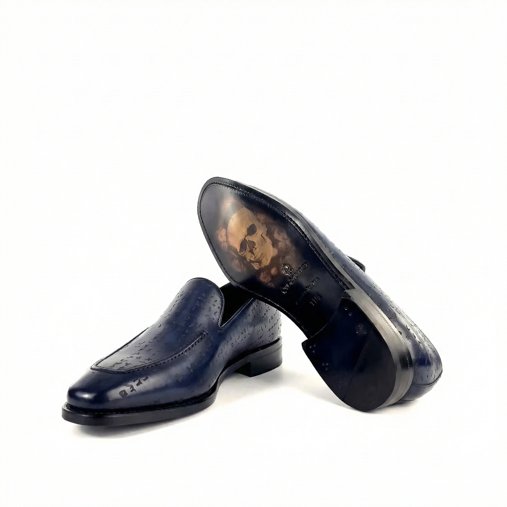 Pair of navy blue leather loafers on a white background