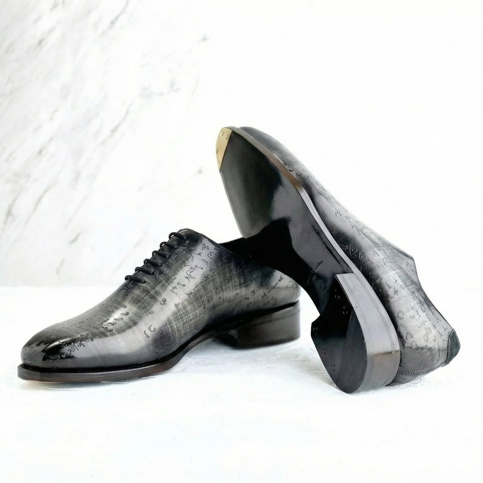 Pair of black dress shoes on a light gray background