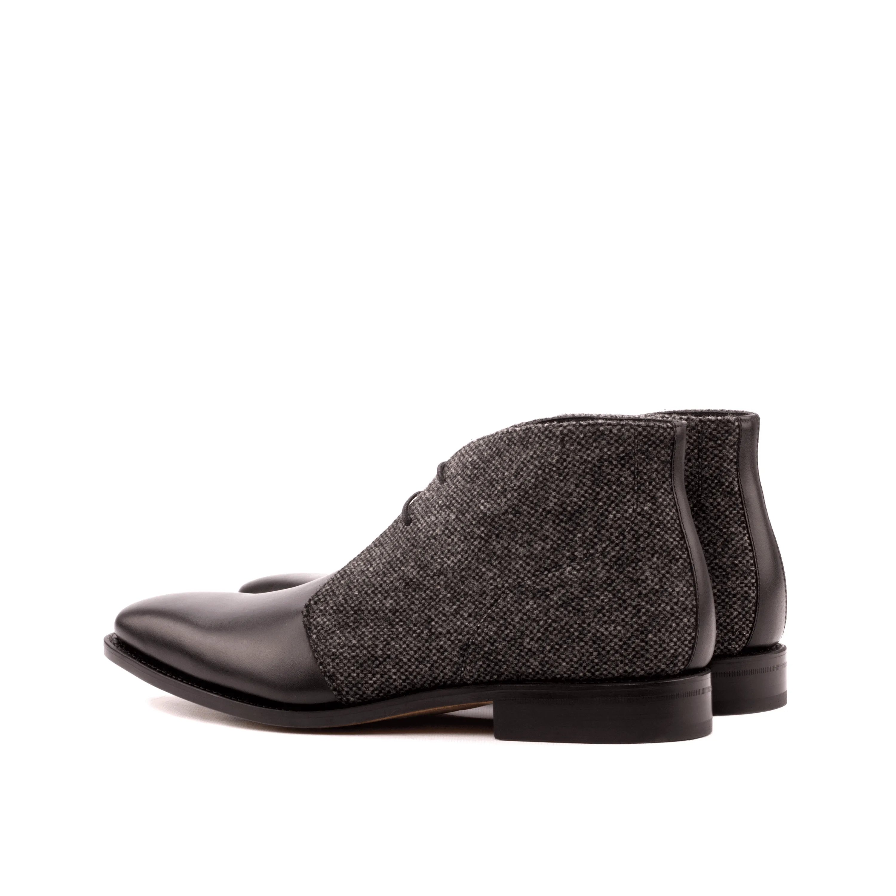Two-toned leather and tweed Artemon Chukka boots showcased in a stylish setting