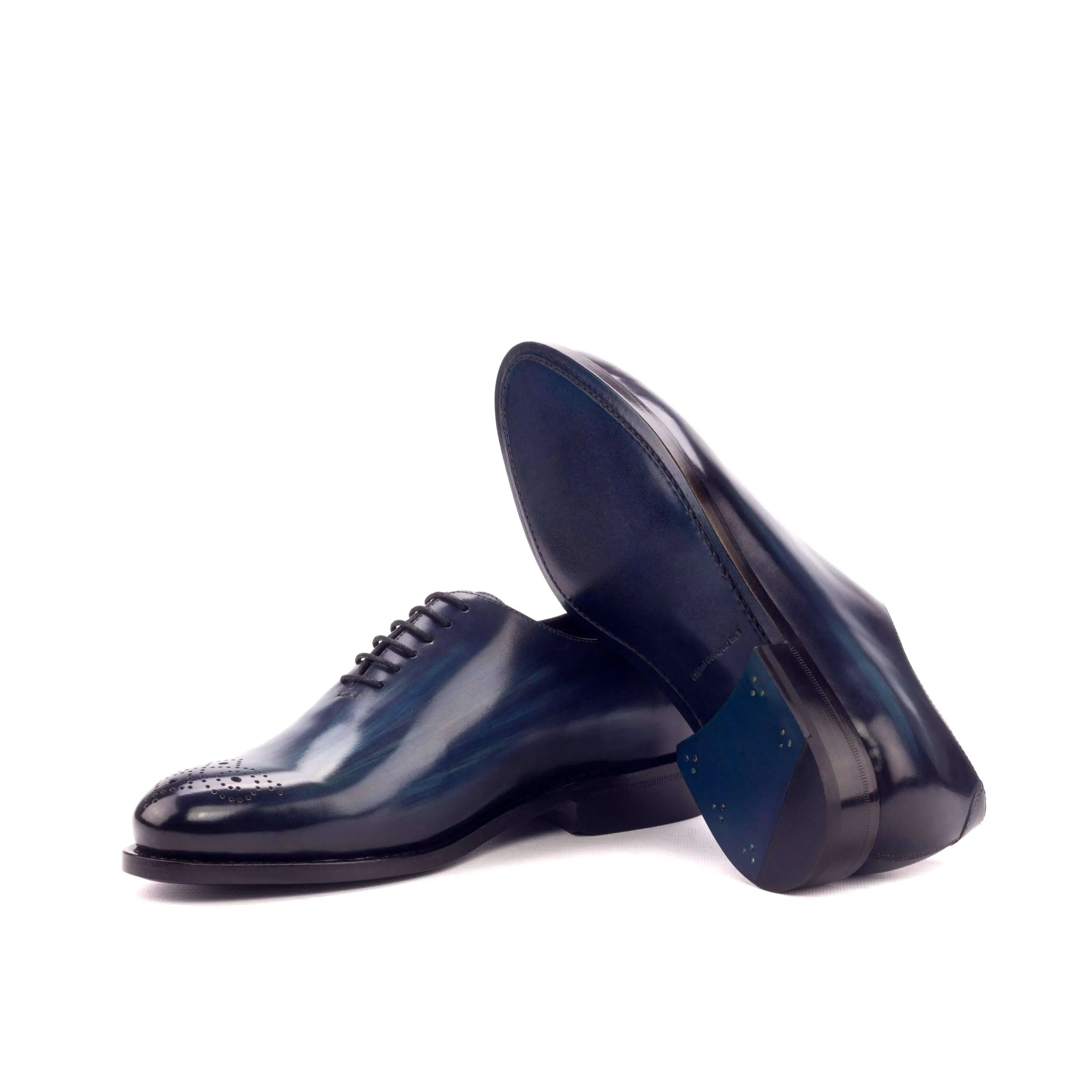 Pair of shiny blue leather dress shoes from the Bluemoon Wholecut Patina collection