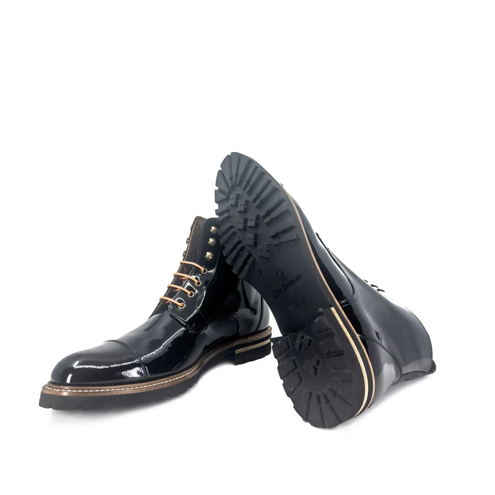 Black patent leather Bossy Unisex Captoe Boots II showcasing stylish captoe boots design