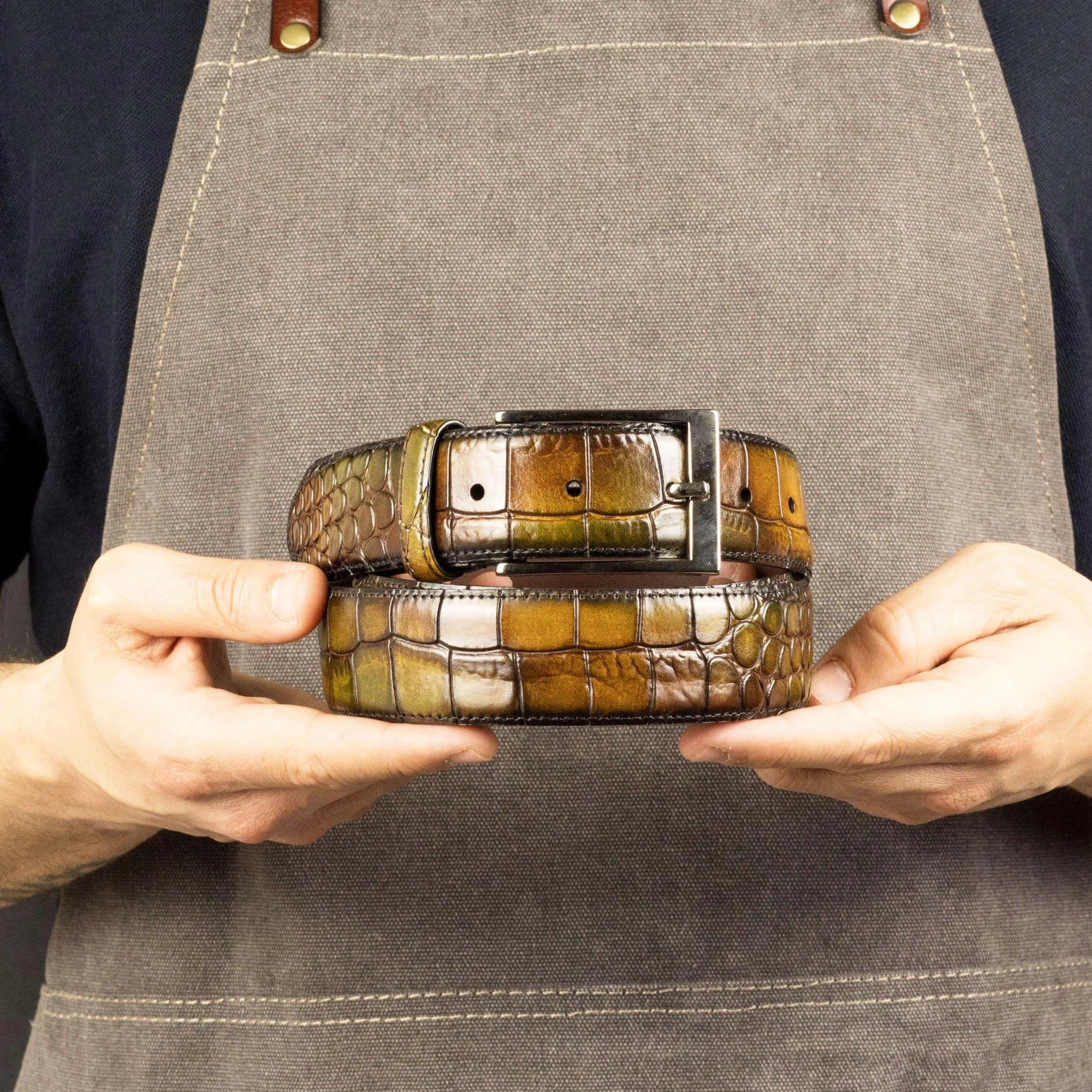 Two stacked multicolored alligator Cairo Patina Hamptons Belts showcasing luxury design