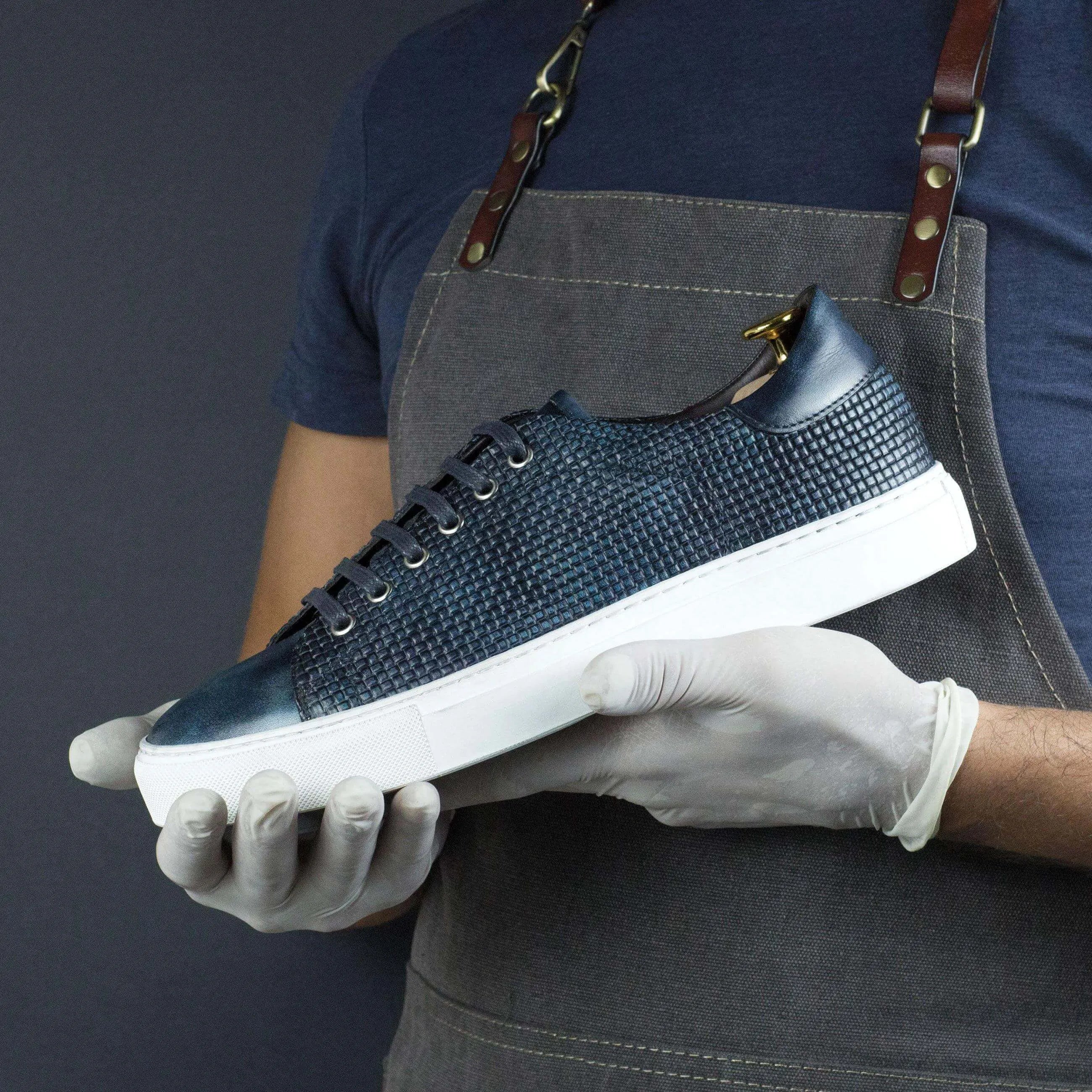 Blue woven leather sneaker named Capa Braided Patina Sneaker II showcasing ocean museum patina