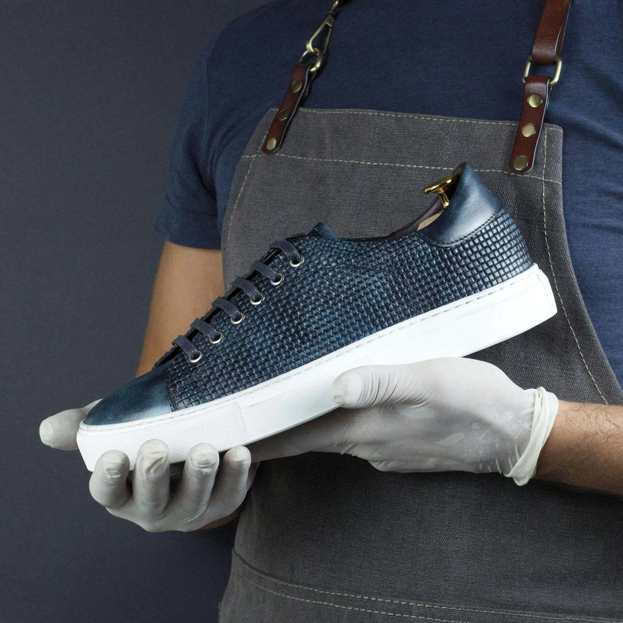 Blue woven leather sneaker, the Capa Braided Patina Sneaker, showcasing ocean museum patina