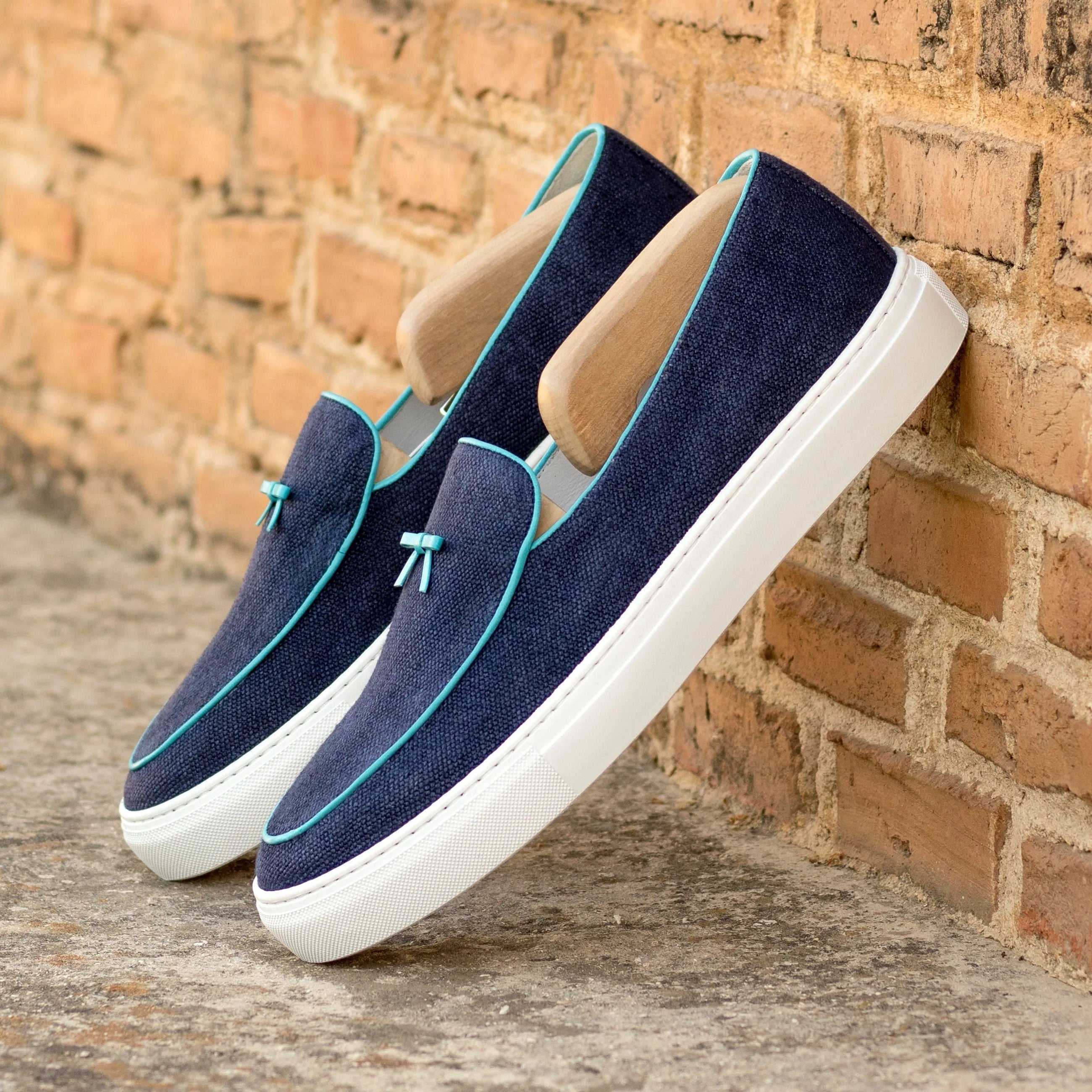 Pair of blue denim slip-on shoes featuring the Chronos Belgian Sneaker design