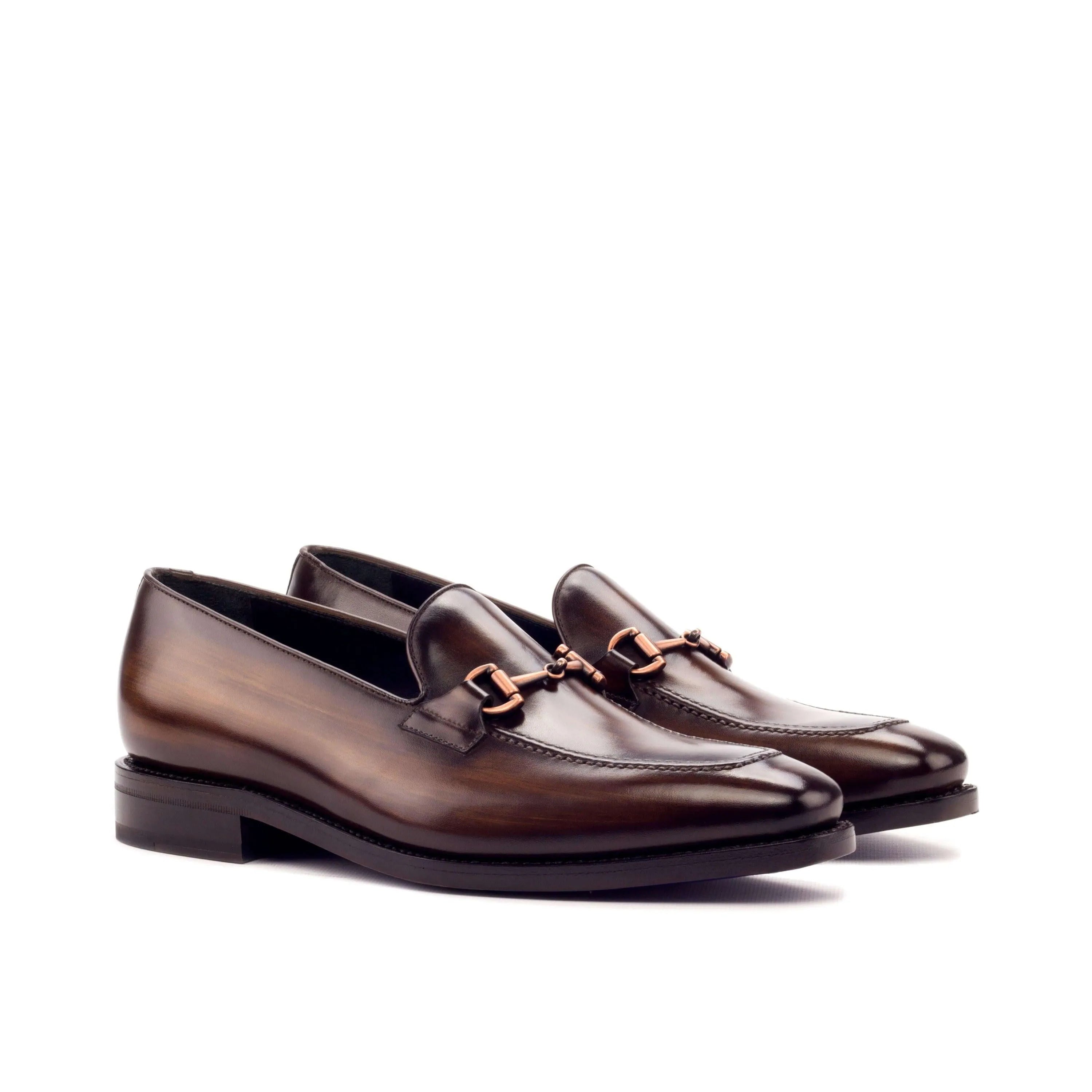 Pair of brown leather Cicli Patina loafers featuring a horsebit design