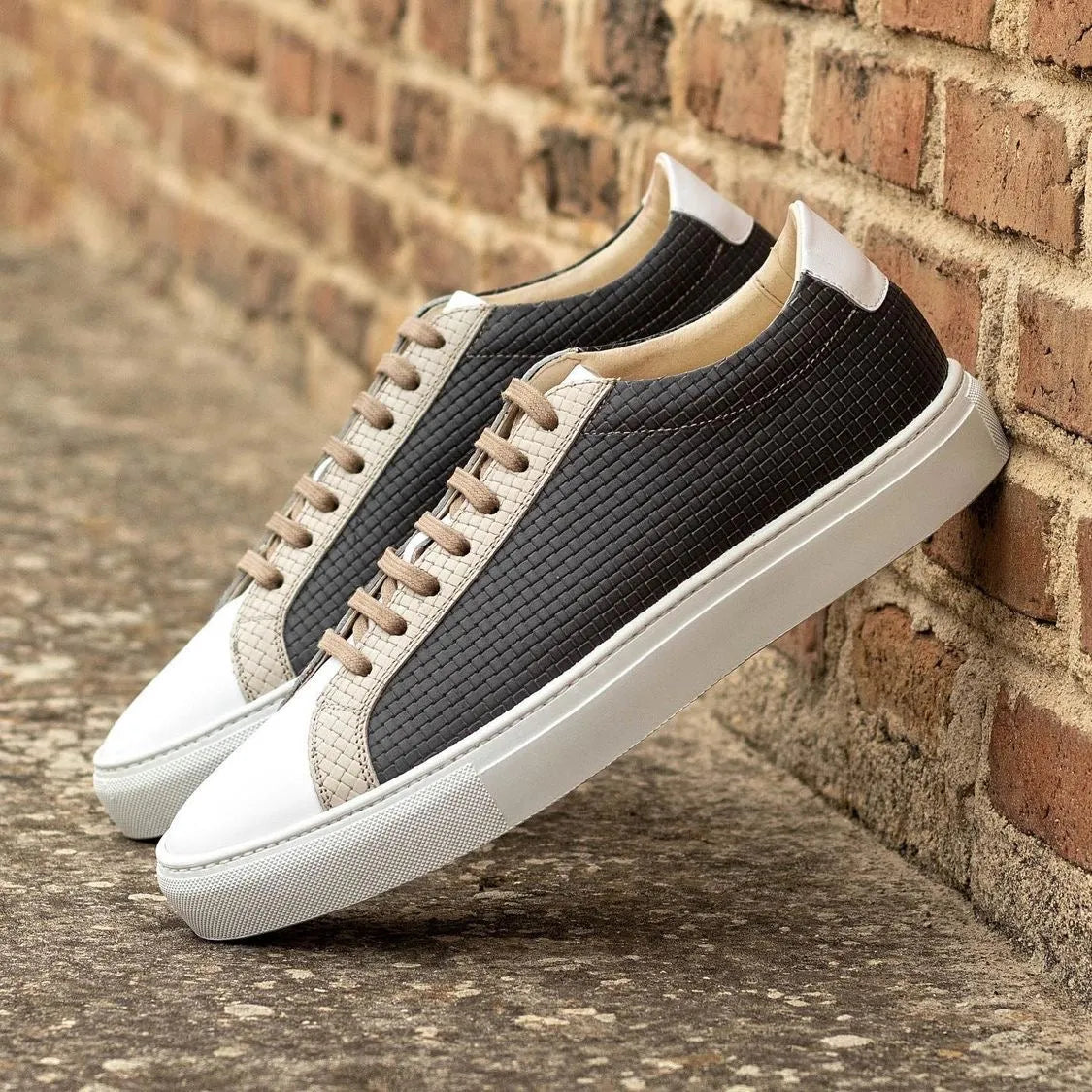 Stylish black and white Cloudy low kick sneaker featuring braided leather design