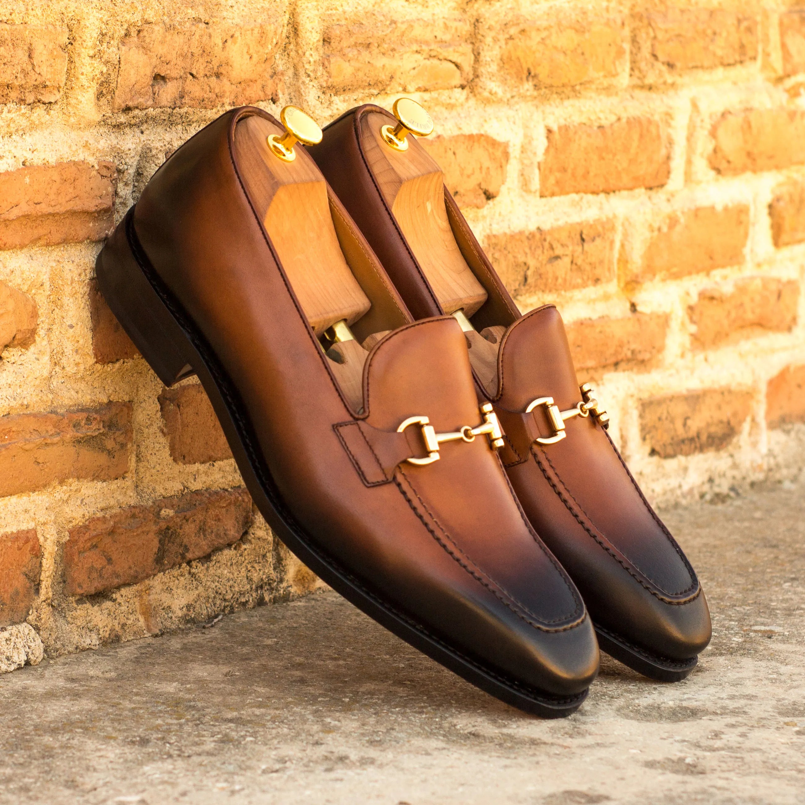 Med brown Cruspos Loafers featuring gold hardware, a luxury bespoke shoe for men