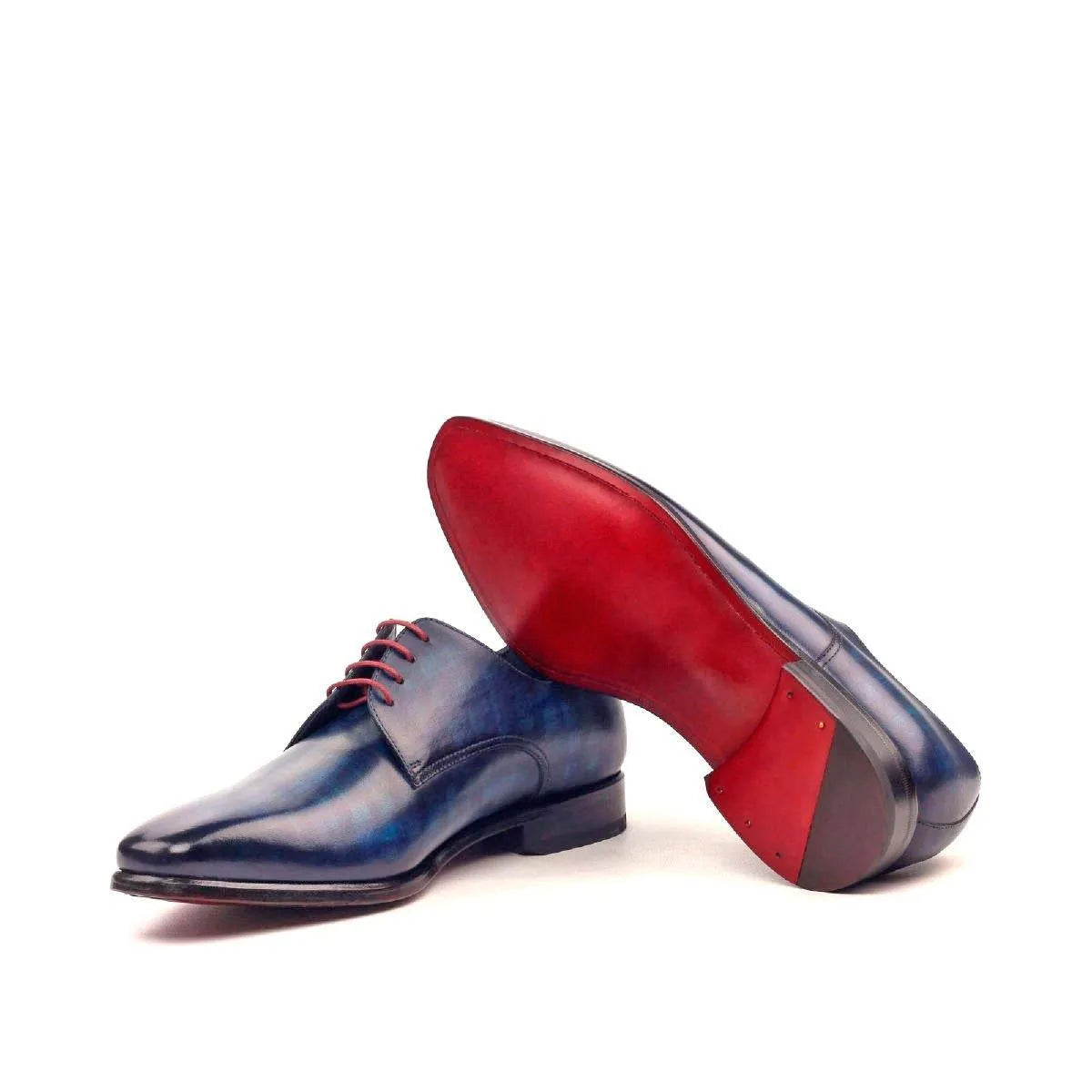 Blue leather Cruz Patina Derby shoes II featuring distinctive red soles for stylish elegance
