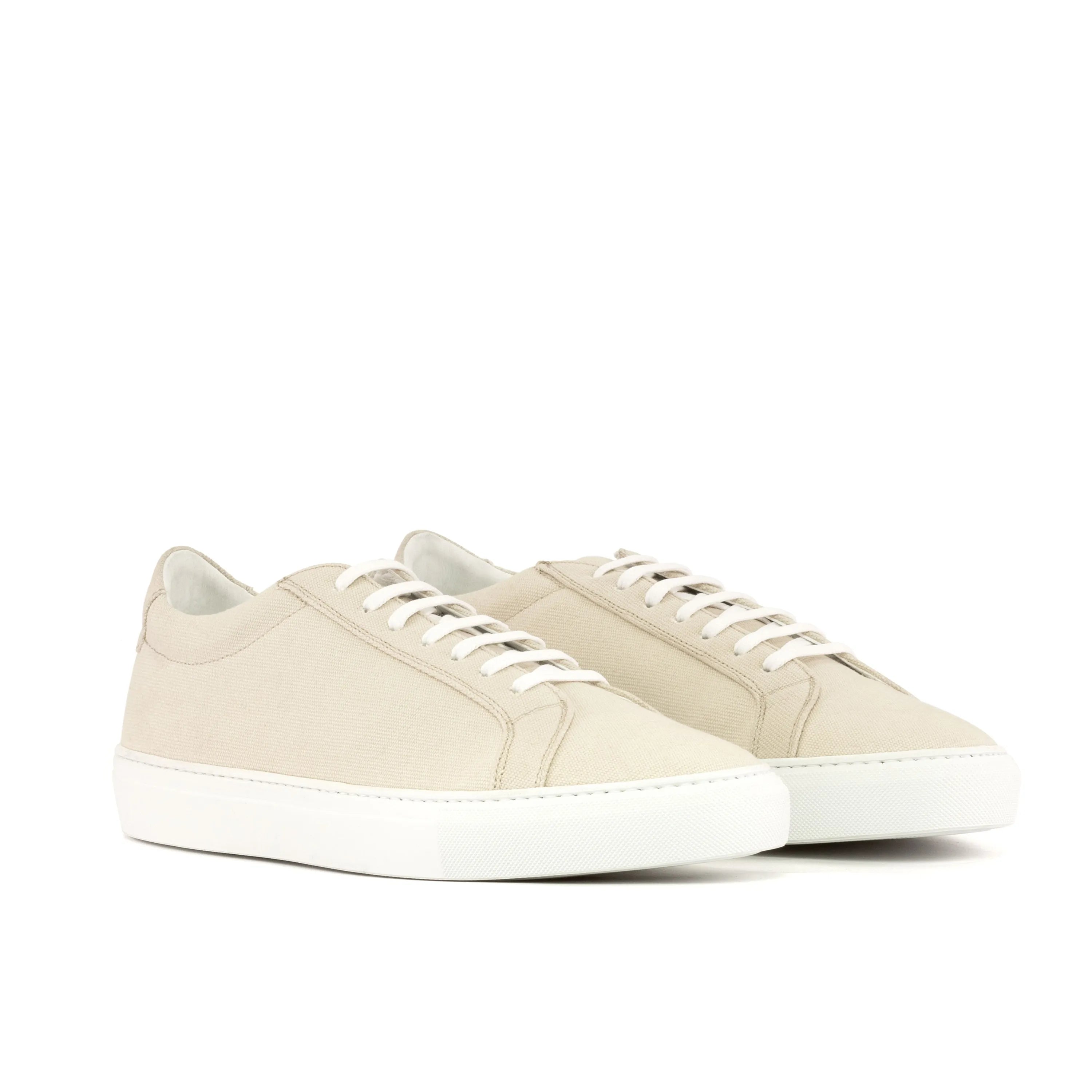 Beige leather sneakers of the Donni Low Kick Vegan Sneaker style
