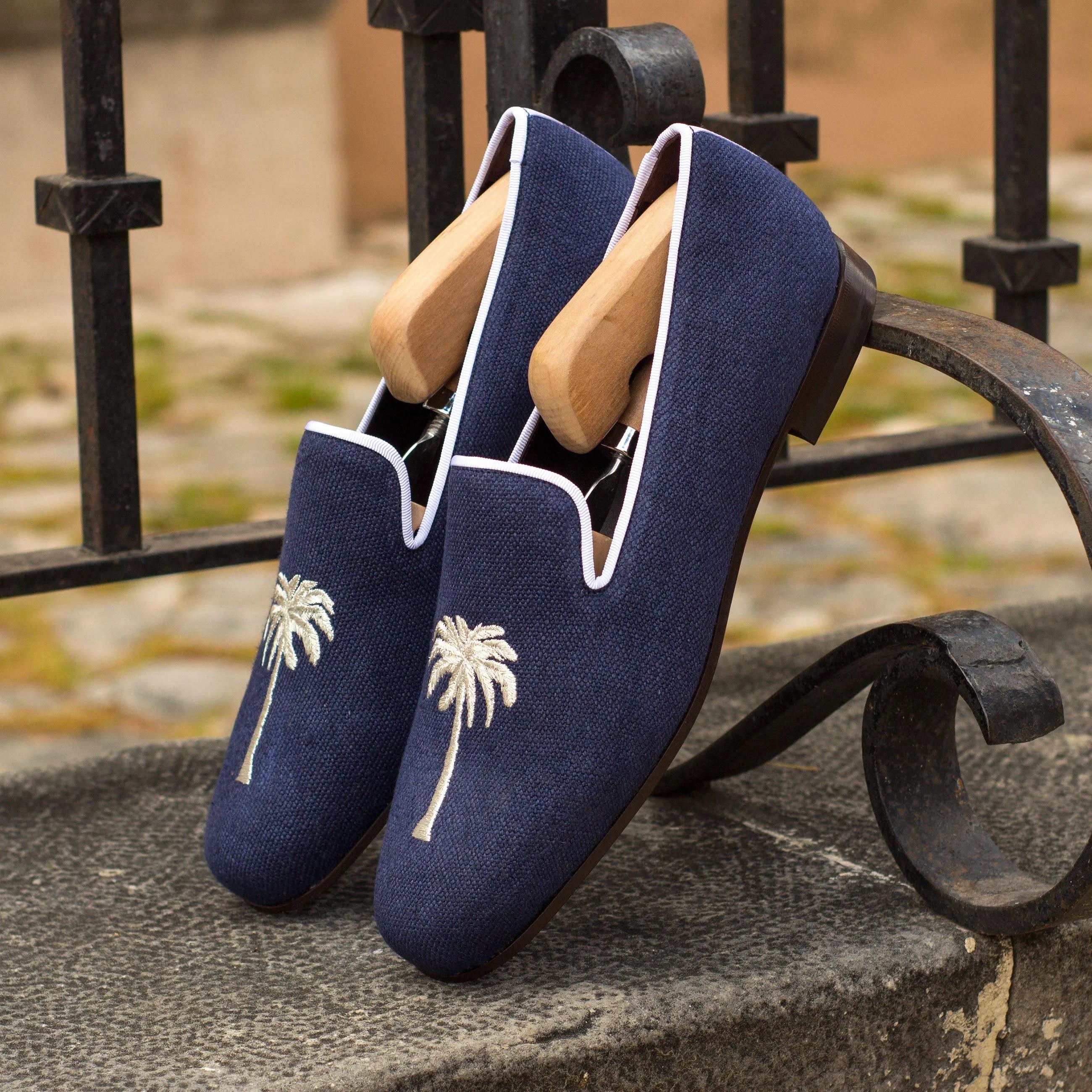 Navy blue loafers with palm tree embroidery from the Eagle Wellington slip collection