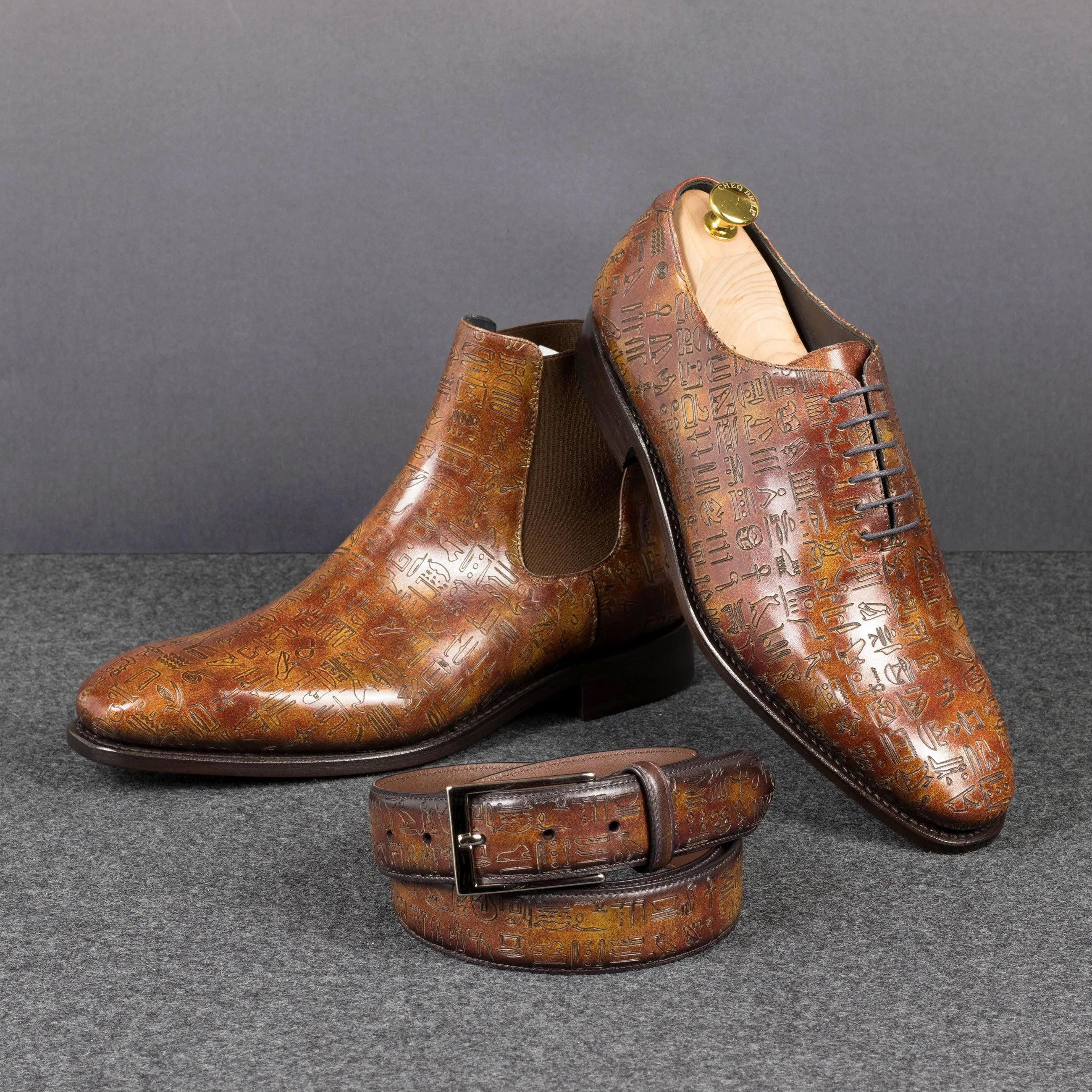 Leather shoes paired with an Egyptian Patina Belt featuring a hieroglyphic pattern