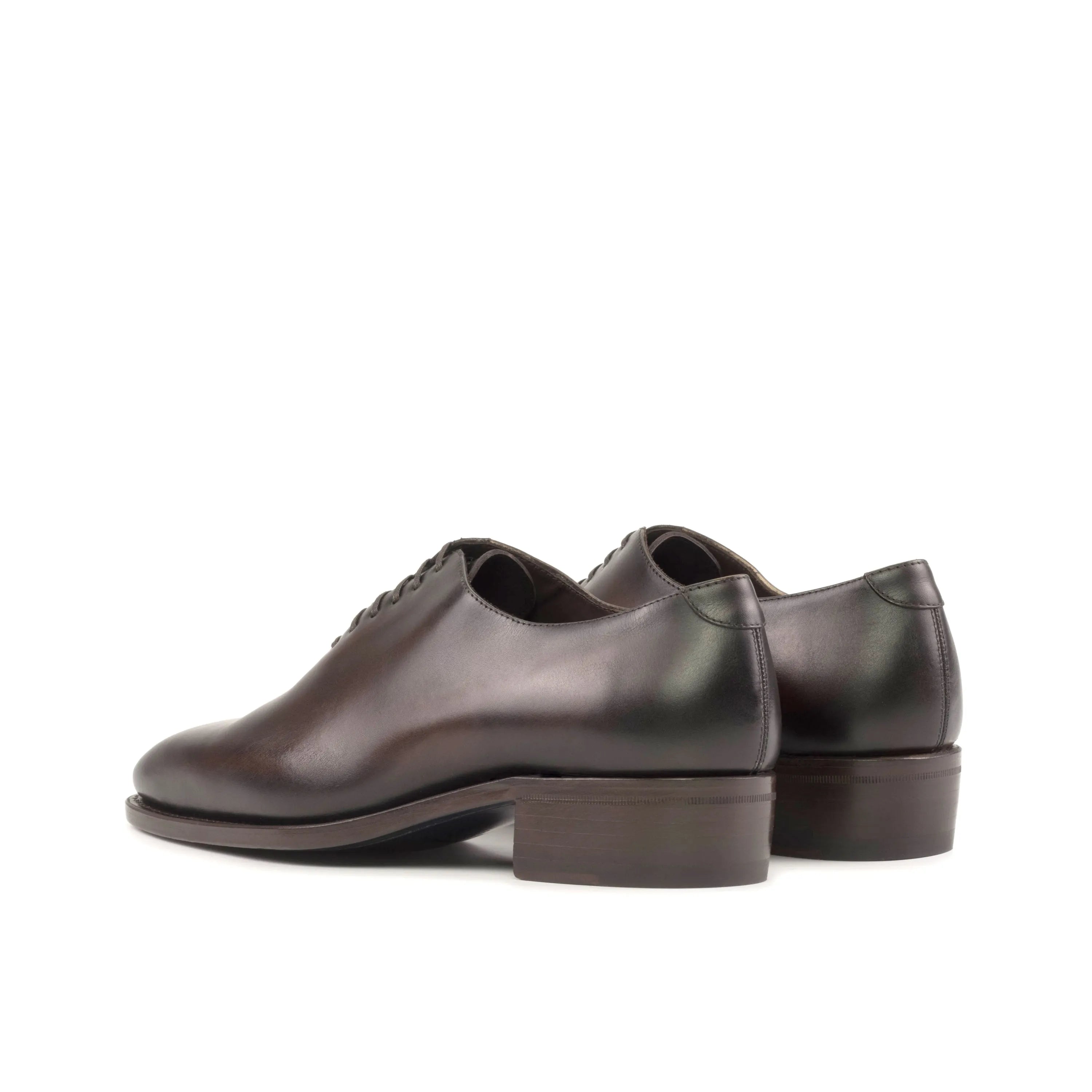 Pair of brown leather Elio Wholecut shoes elegantly displayed for formal attire