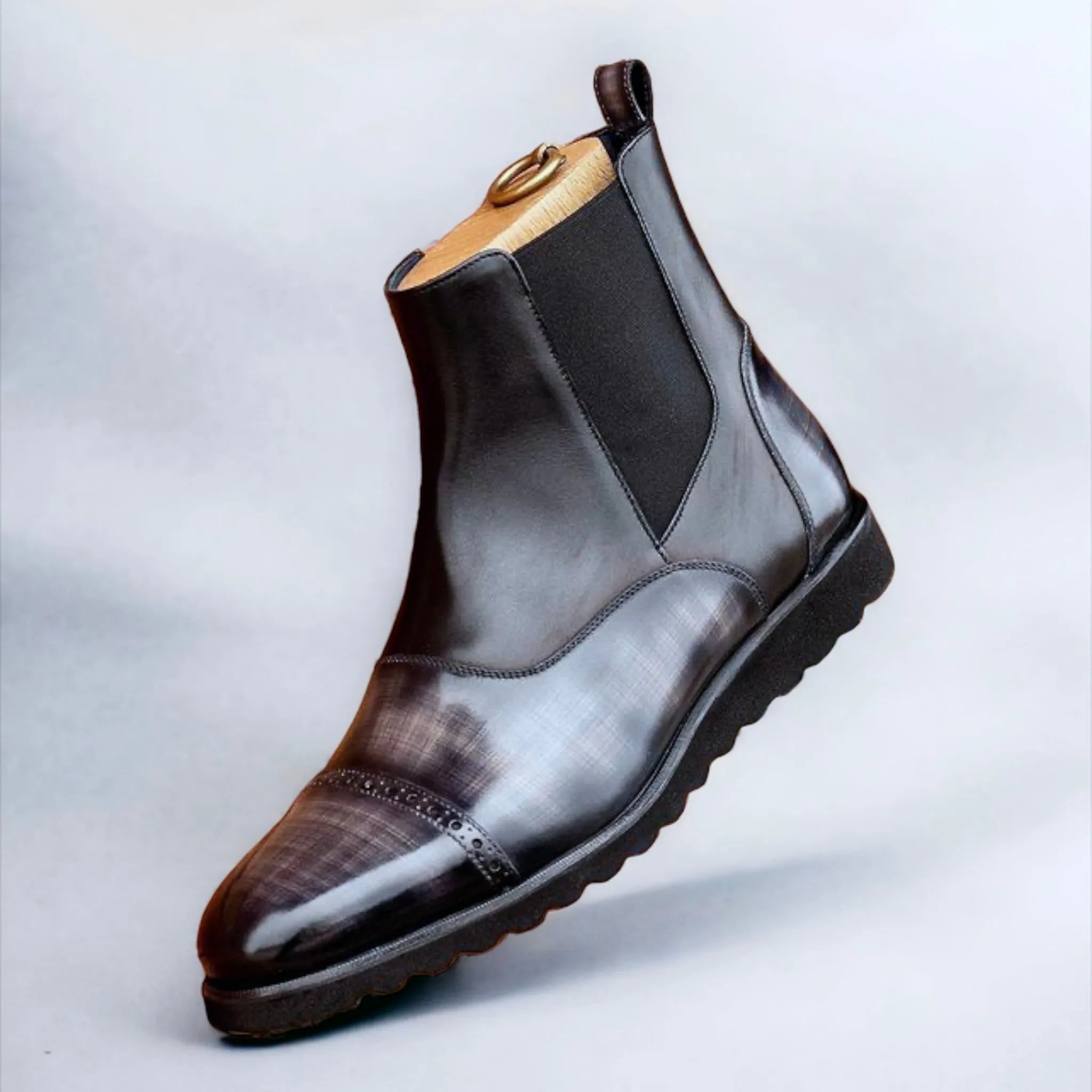 Shiny black leather Elysian Patina Chelsea Boots showcasing modern elegance and style