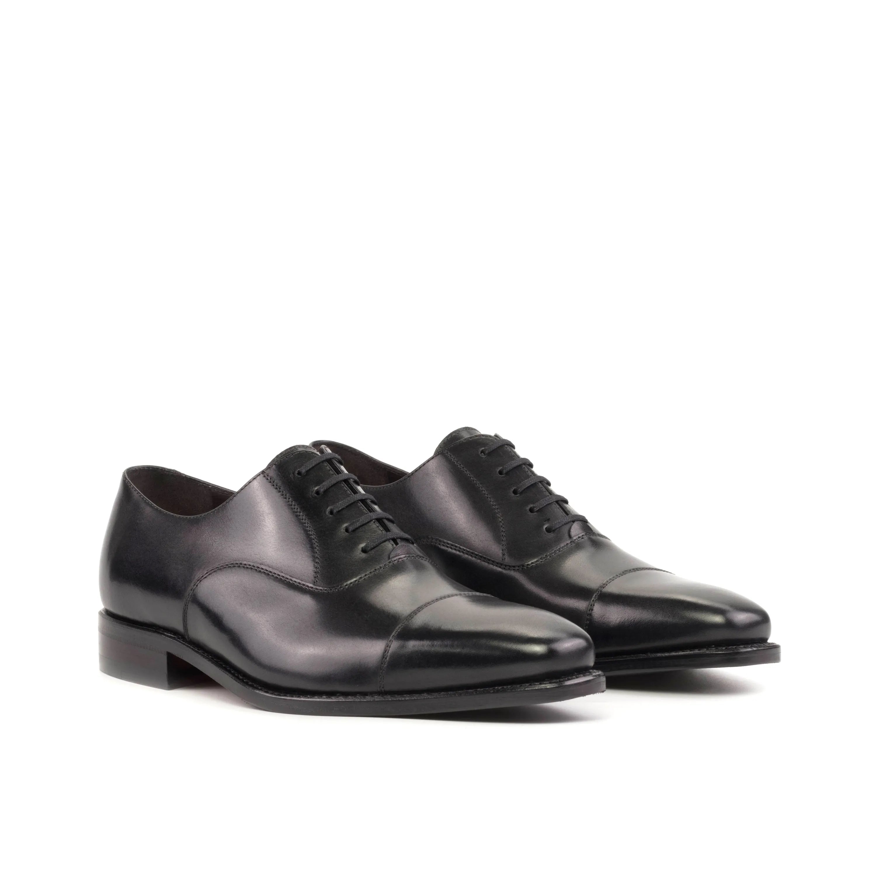 Pair of black leather dress shoes showcased as Farell Oxford shoes for a stylish look