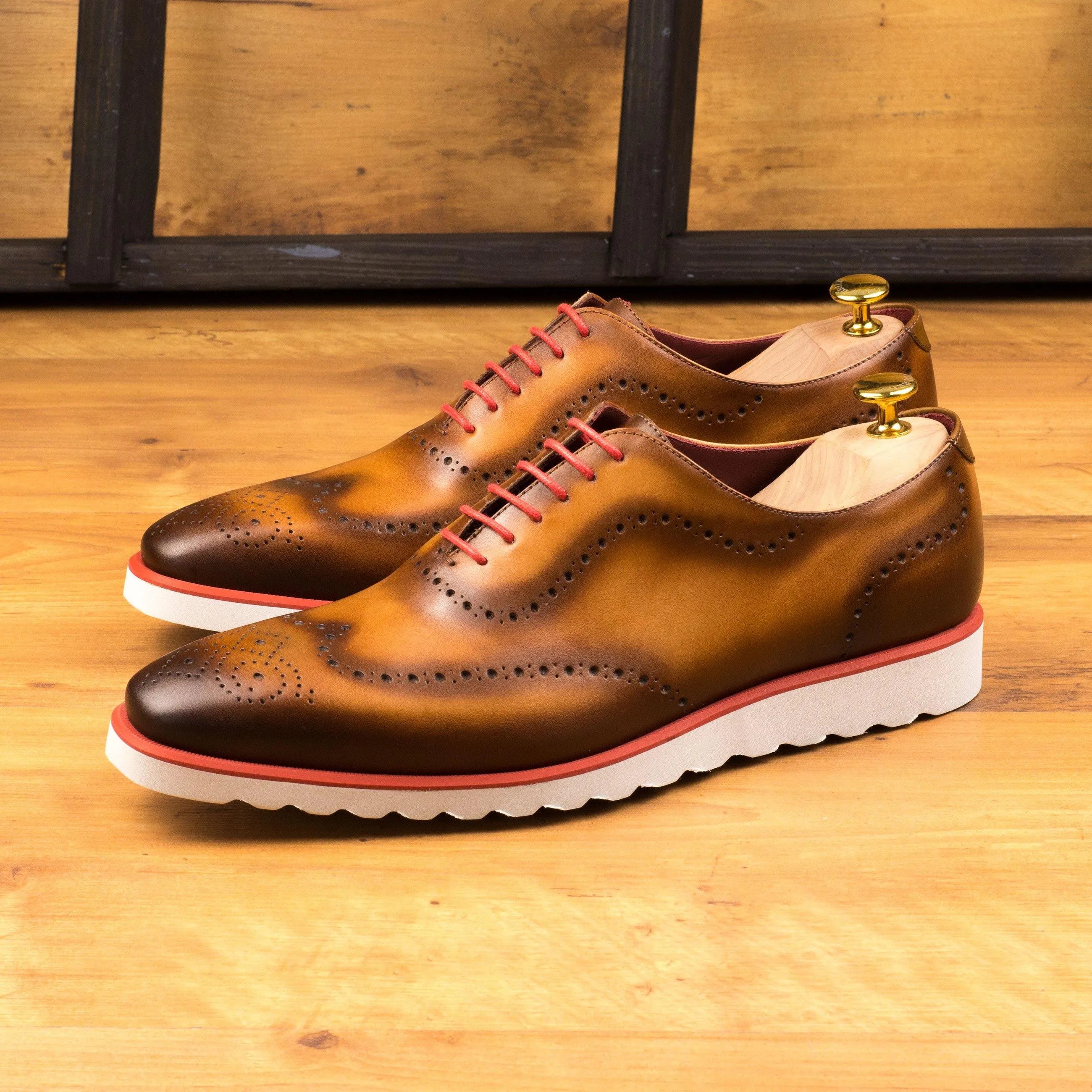 Brown leather wingtip shoes from the Faro WholeCut collection showcasing elegant craftsmanship