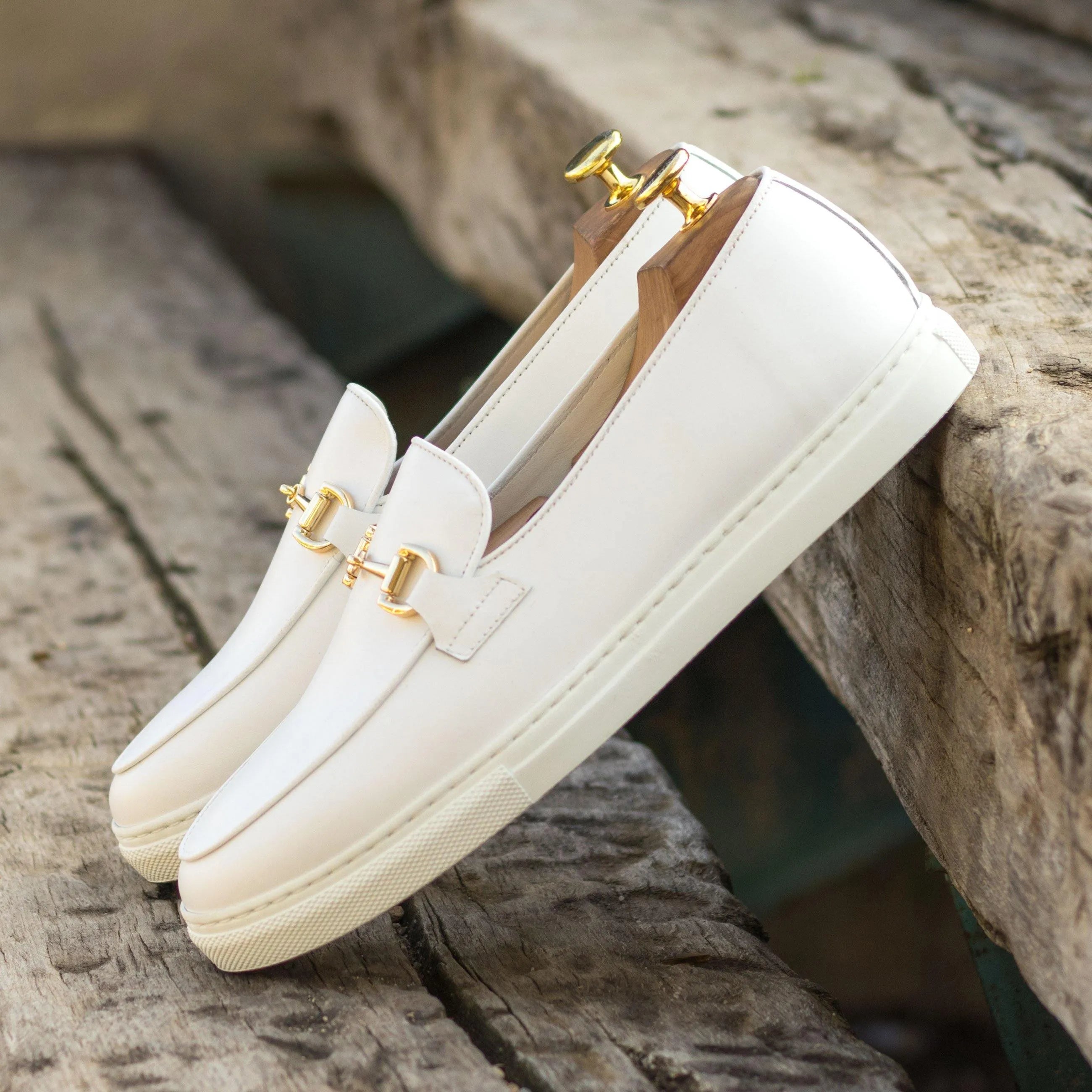 Pair of white leather loafers with gold hardware, part of the Frais Belgian sneaker collection
