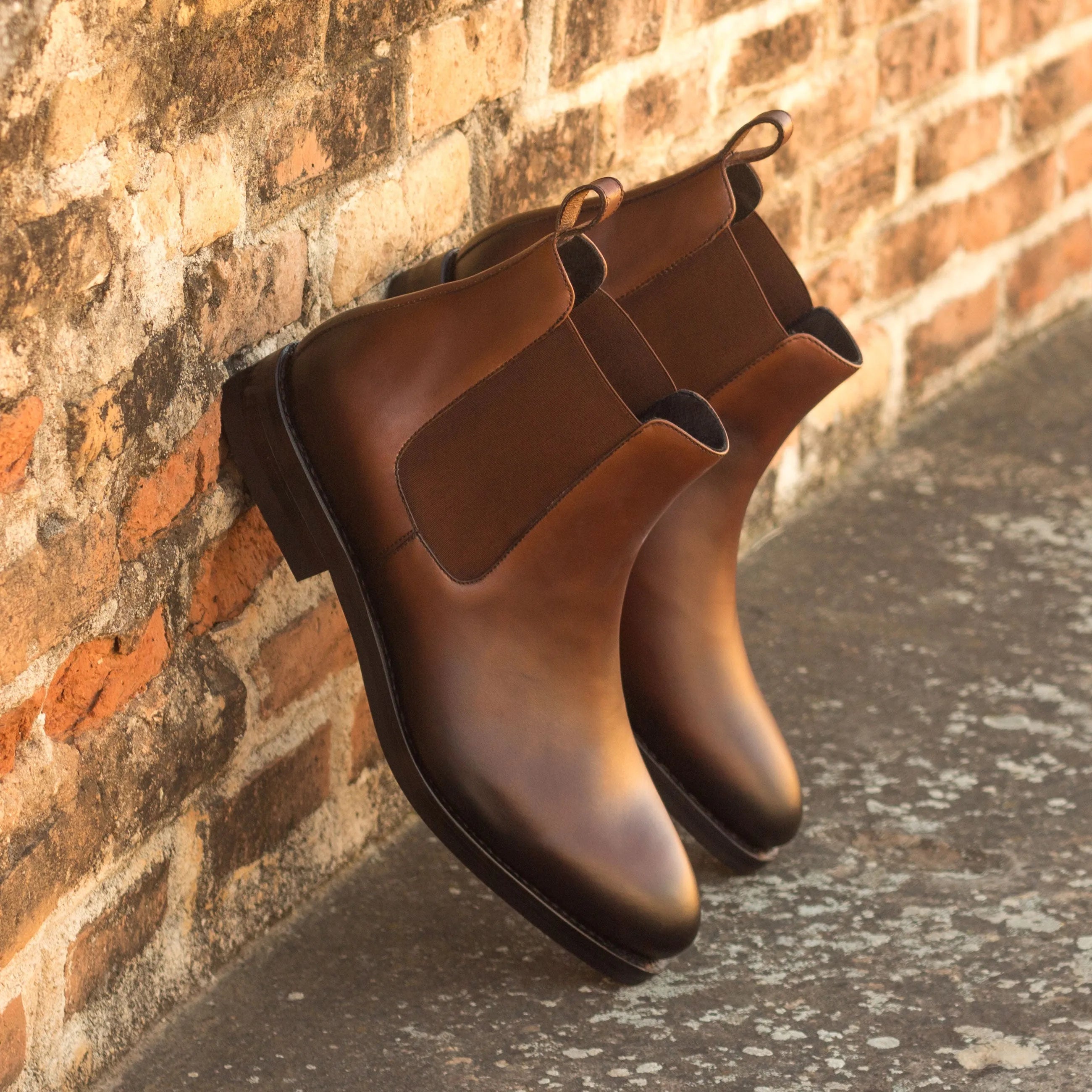 Pair of brown leather Gall Chelsea Boots showcasing classic style and elegance