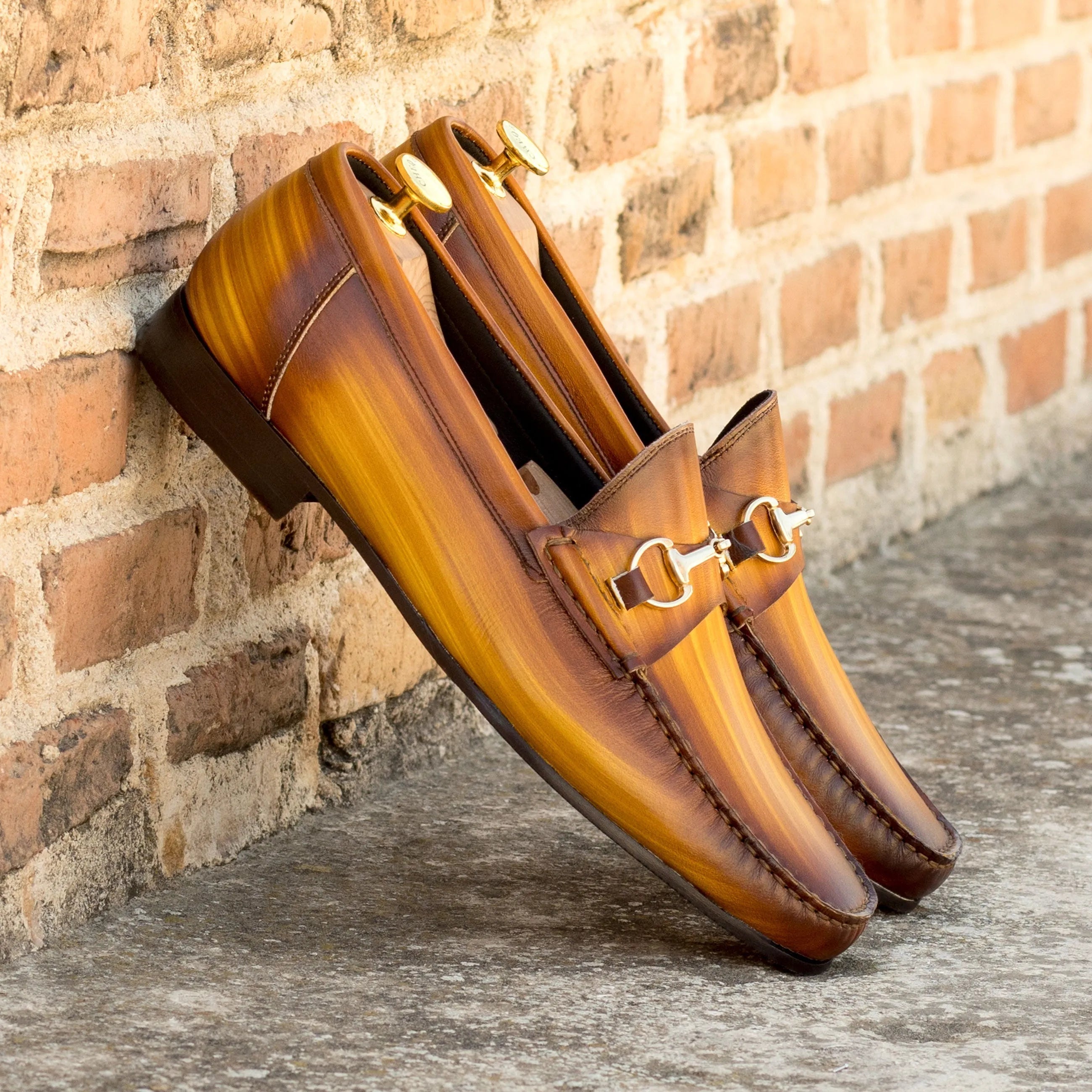 Pair of brown leather loafers featuring the Garanti Patina Moccasin design