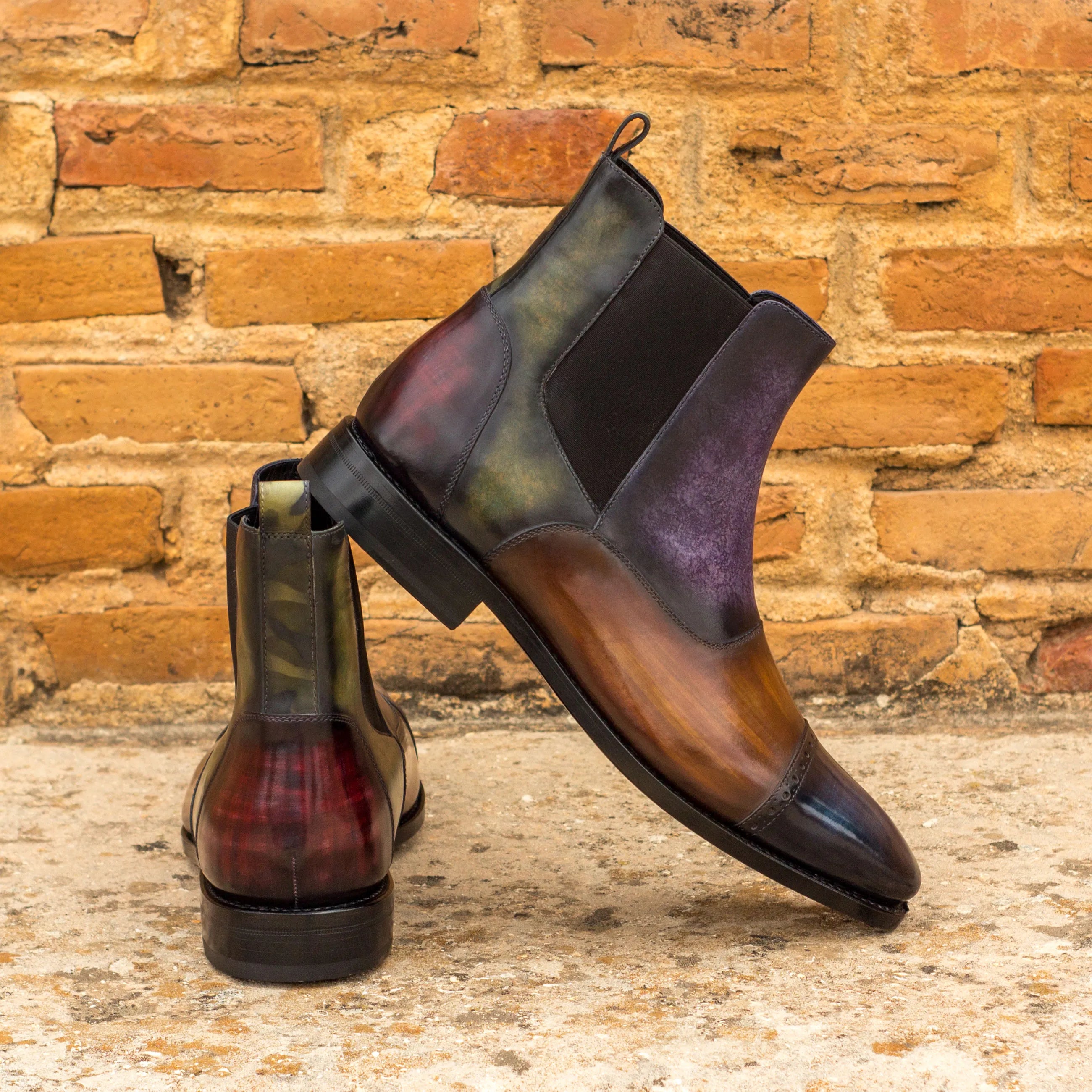 Two colorful leather Glaucia Chelsea Boots featuring a unique crust patina finish