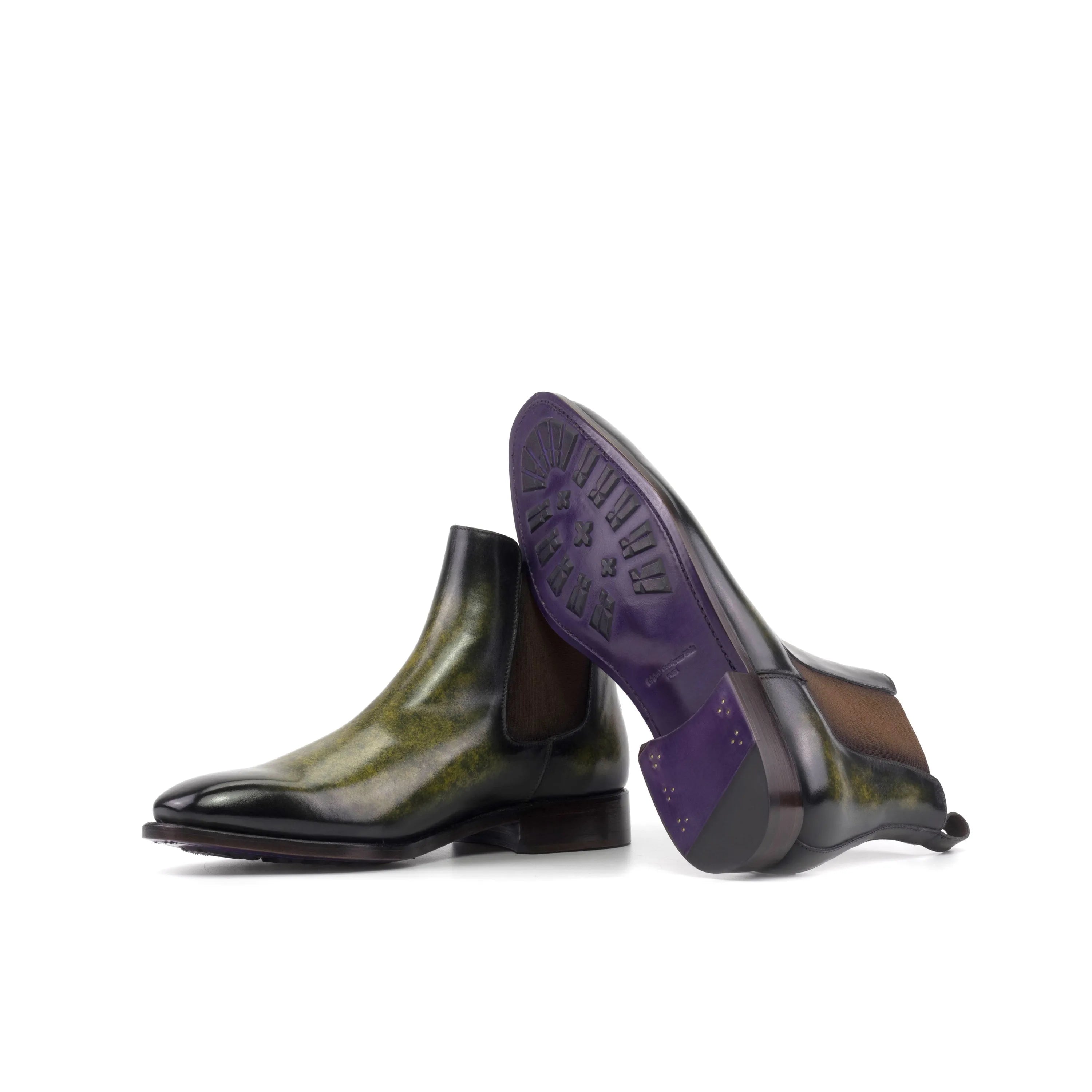 Green and black Ivoire Patina Chelsea Boots with stylish purple soles