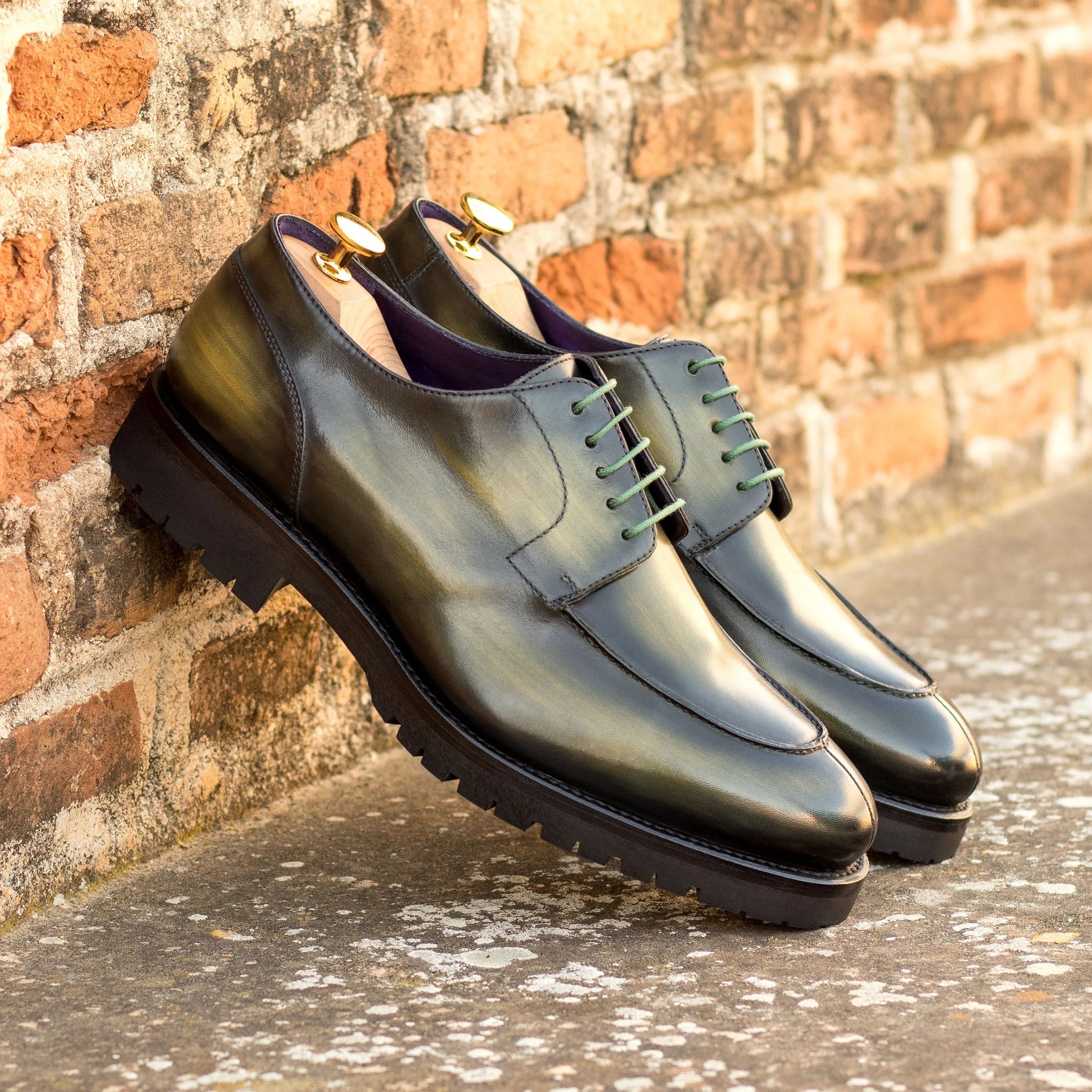 Green leather Jarama Derby Split Toe Patina shoes showcasing elegant craftsmanship