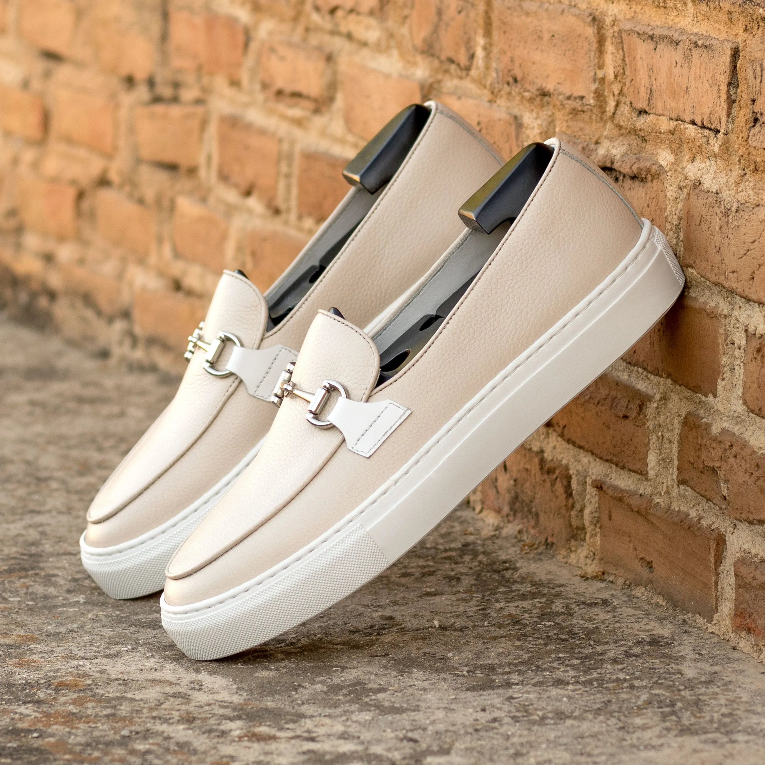 Pair of beige leather loafers showcasing the Jbien Belgian Sneaker design