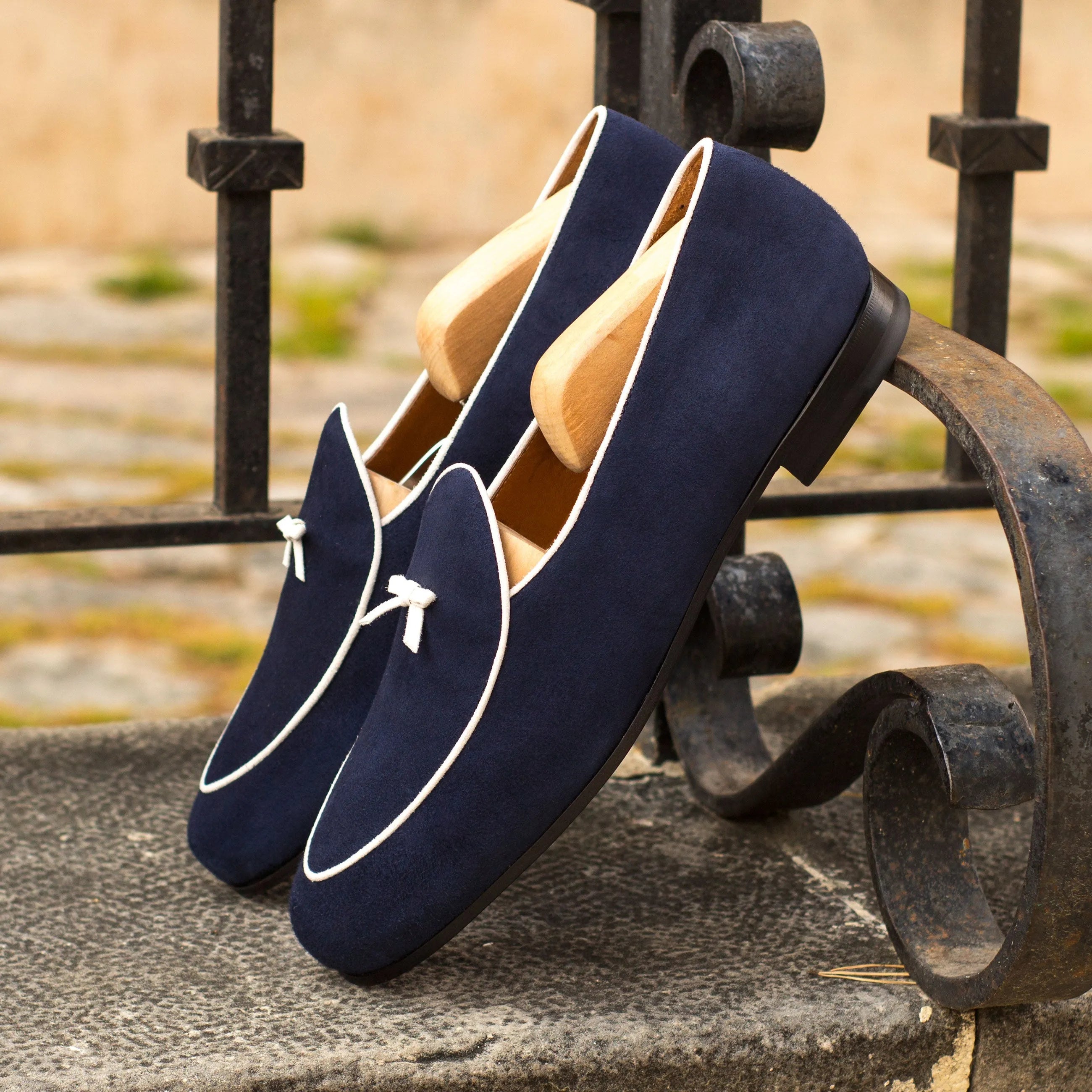 Navy blue Kannan Belgian Slipper with stylish white trim for elegant footwear