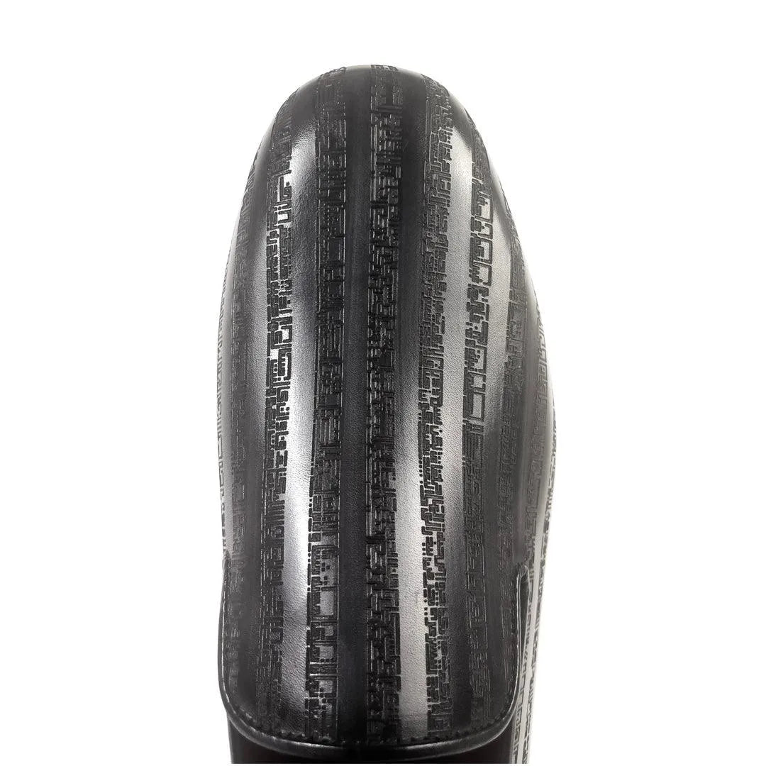 Black striped boot showcasing Khalil Patina Wellington Slip-On for stylish footwear