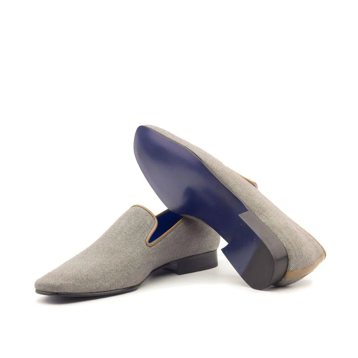 Gray textured loafers with cobalt blue soles, part of the Drake Slipon luxury shoes for men