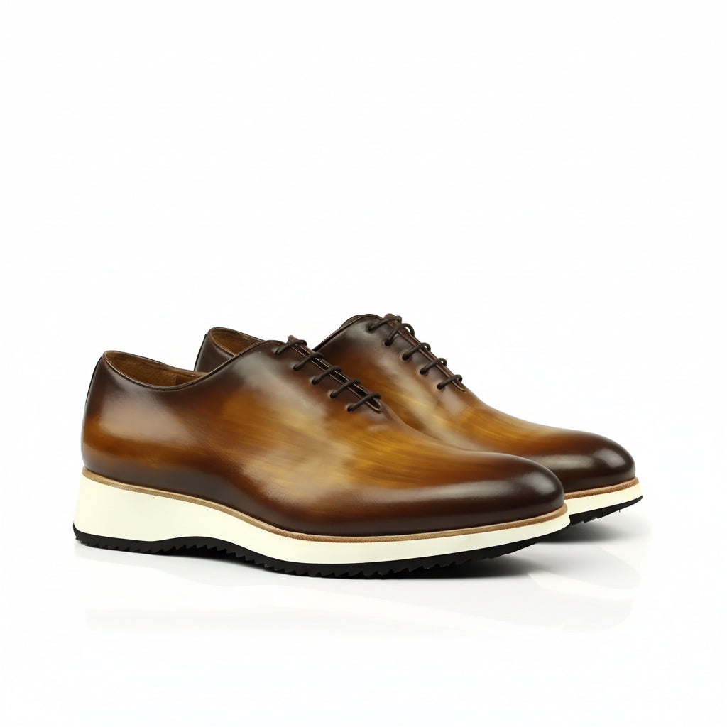 Brown leather Lloyd Wholecut Patina shoes showcasing elegant craftsmanship and style
