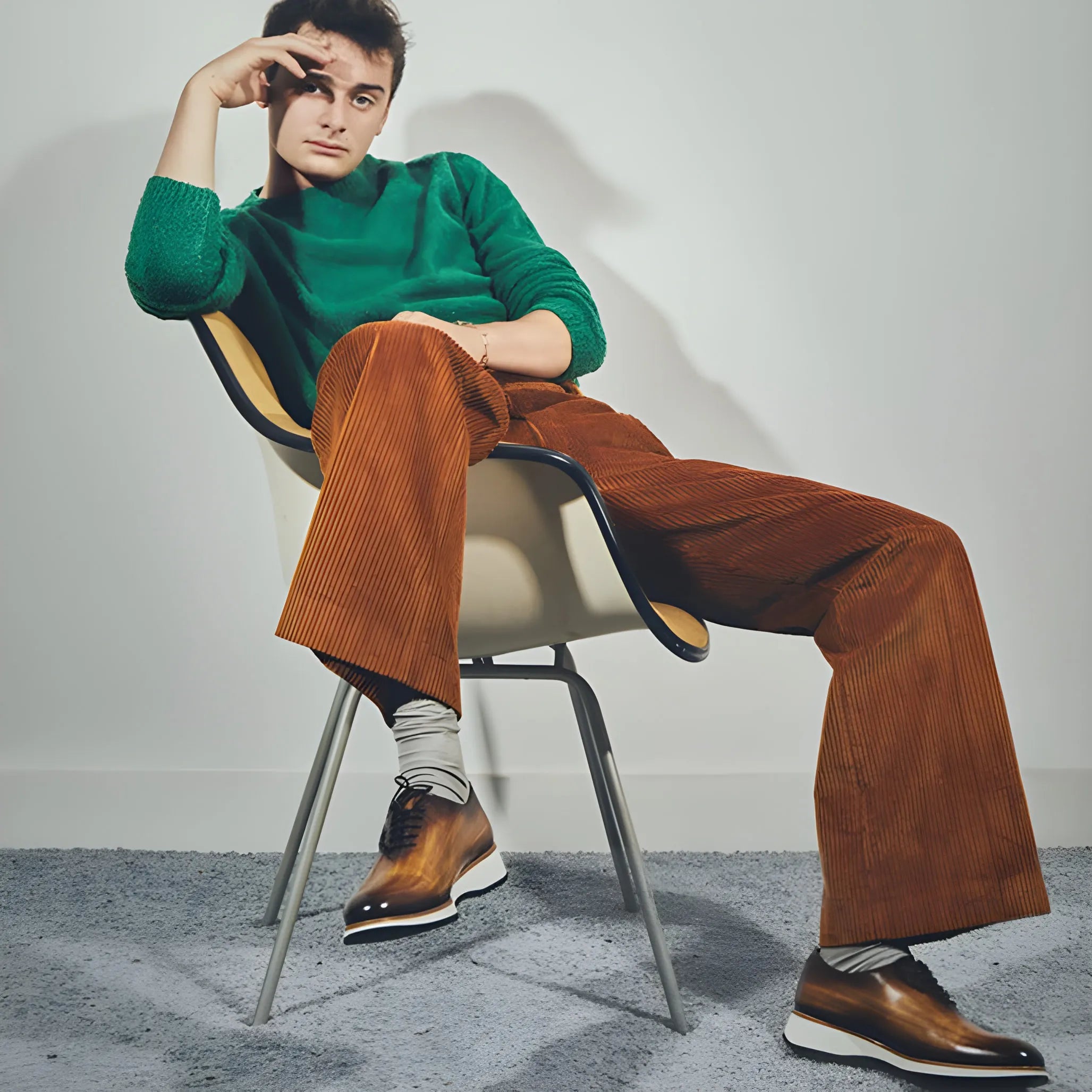 Man in green sweater and brown corduroy pants wearing Lloyd Wholecut Patina shoes