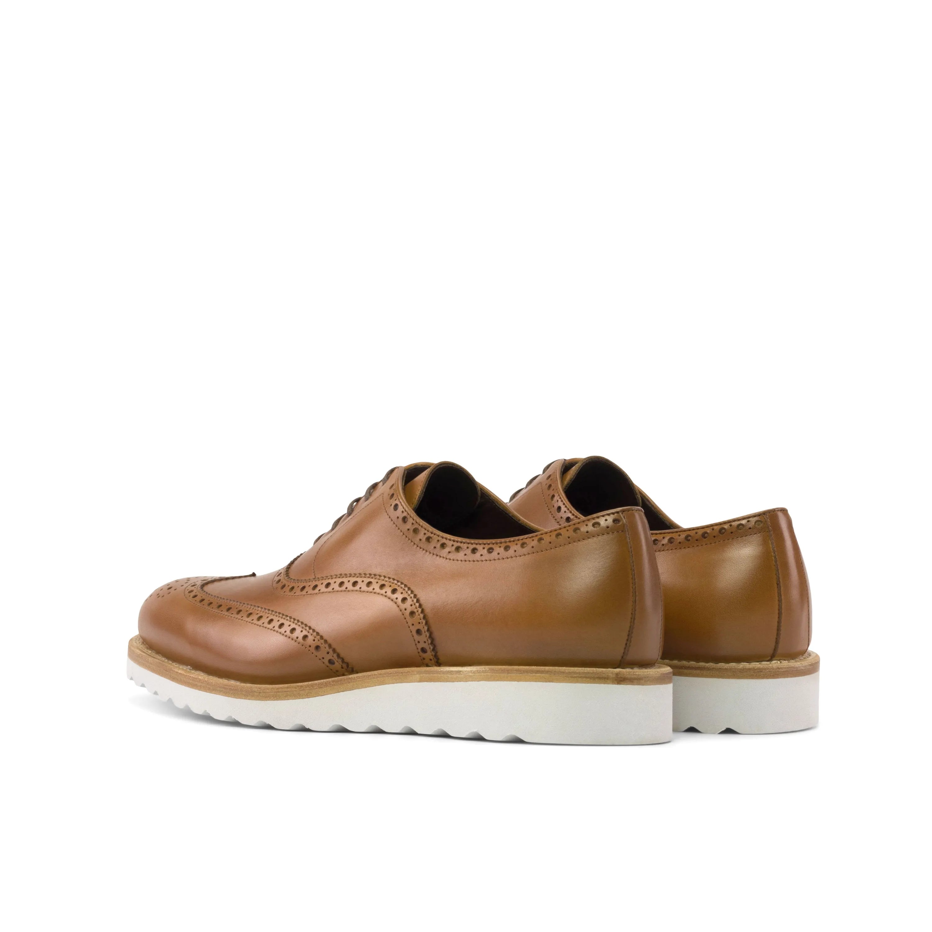 Brown leather wingtip brogue shoes with white soles for a stylish dress shoe option