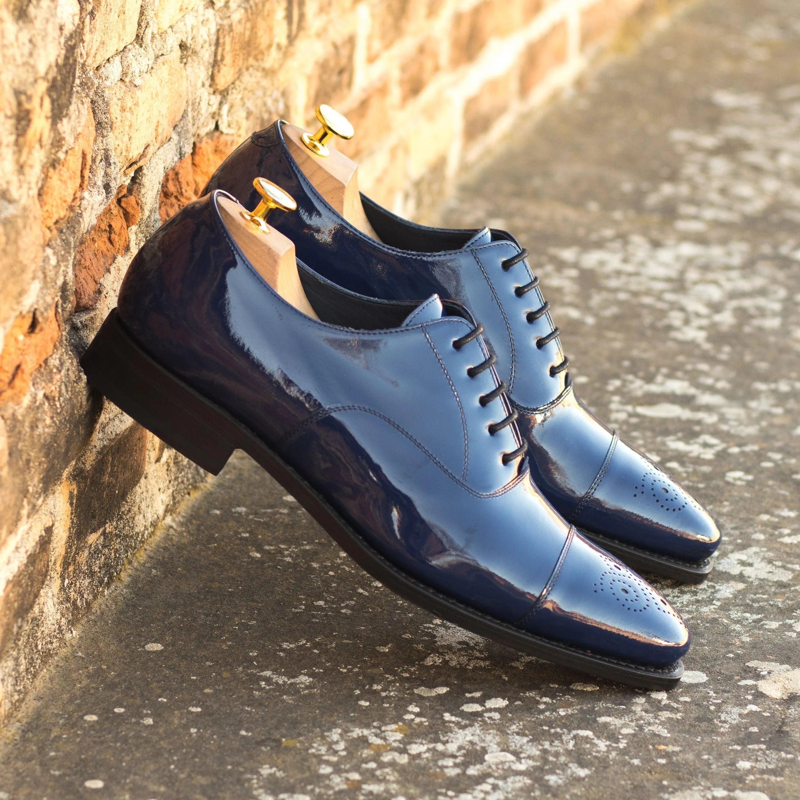 Pair of shiny blue Lusio Oxford Shoes showcasing elegant style and premium craftsmanship