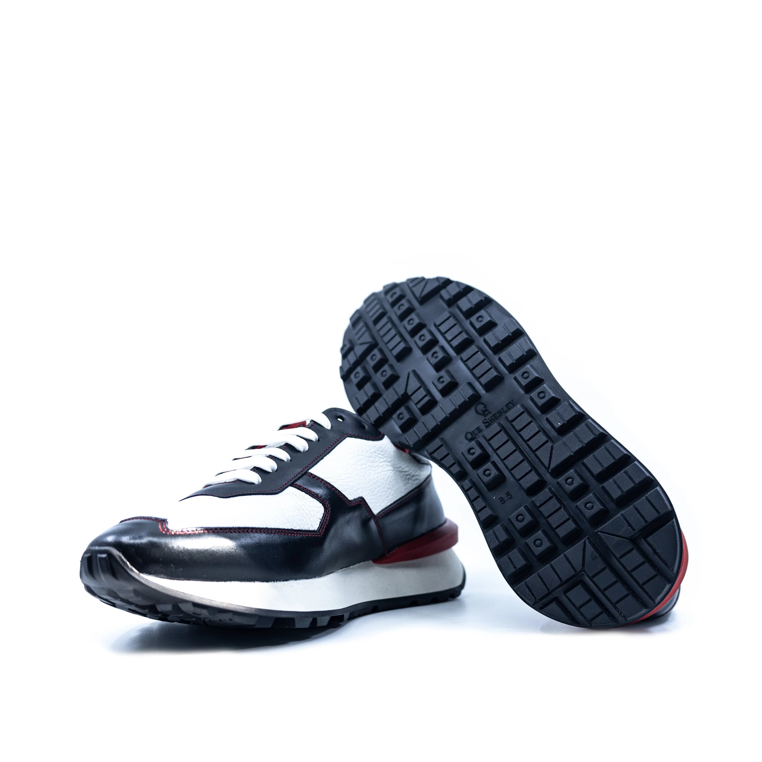 M10 Chunky Tempo Trainer: white and black Italian leather sneaker with red accents and exaggerated proportions