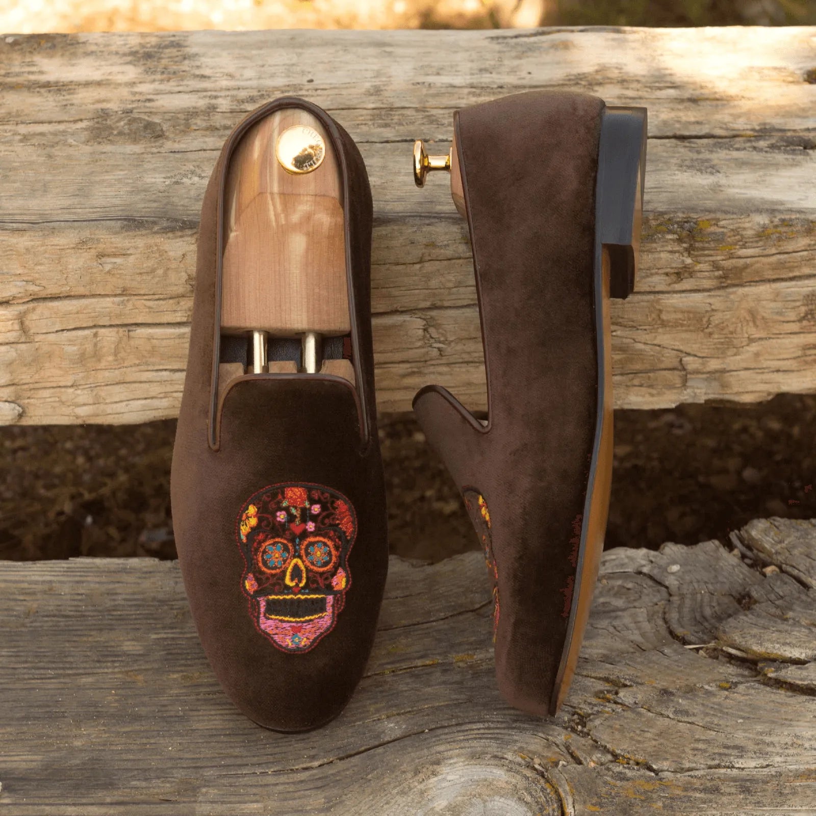 Brown velvet slippers featuring skull embroidery from the Mizarble Wellington slip collection